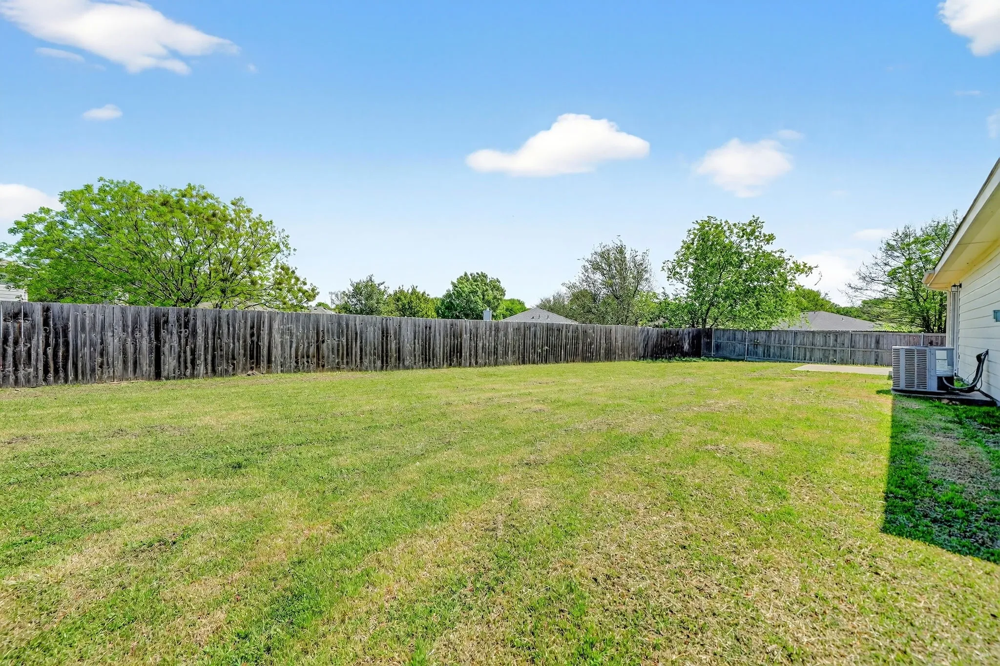 View of fenced backyard