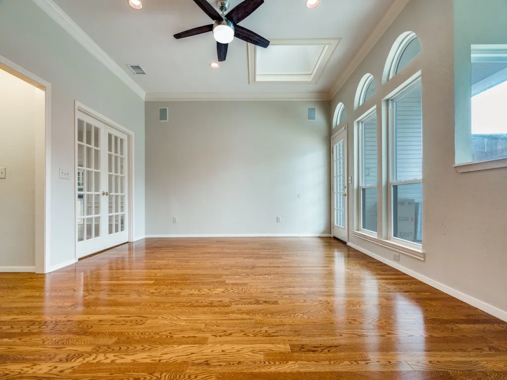 Unfurnished room with french doors, light hardwood / wood-style flooring, ceiling fan, and crown molding