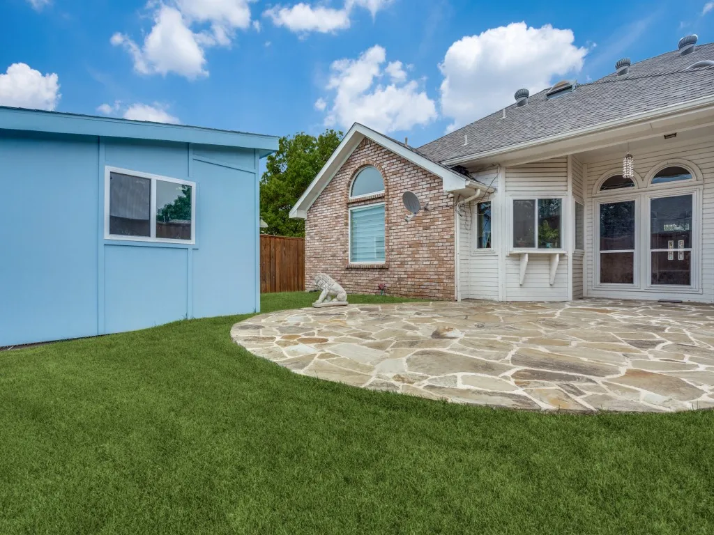 Back of house featuring a patio area and a lawn