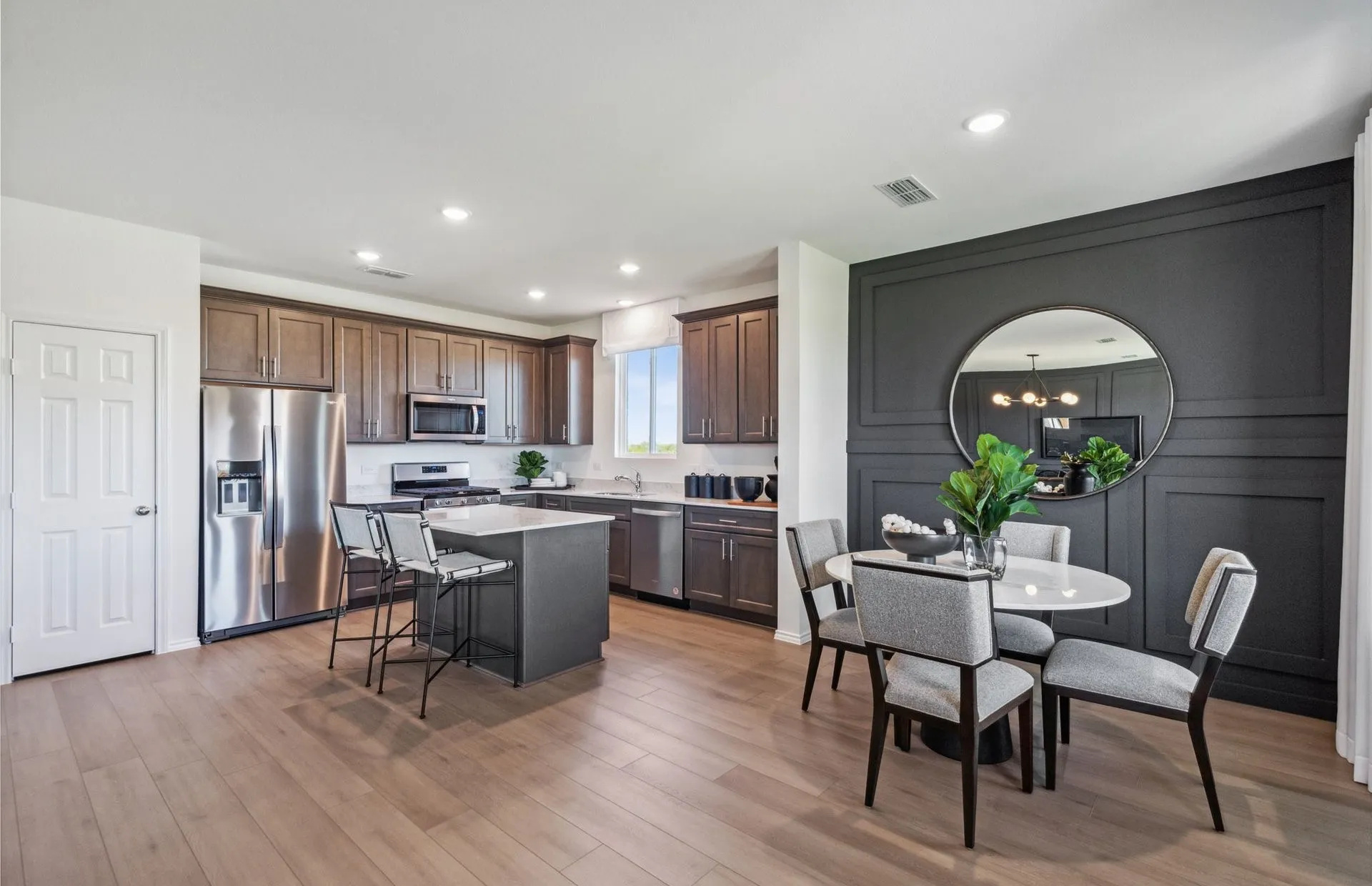 Dining nook off kitchen with large windows *model representation