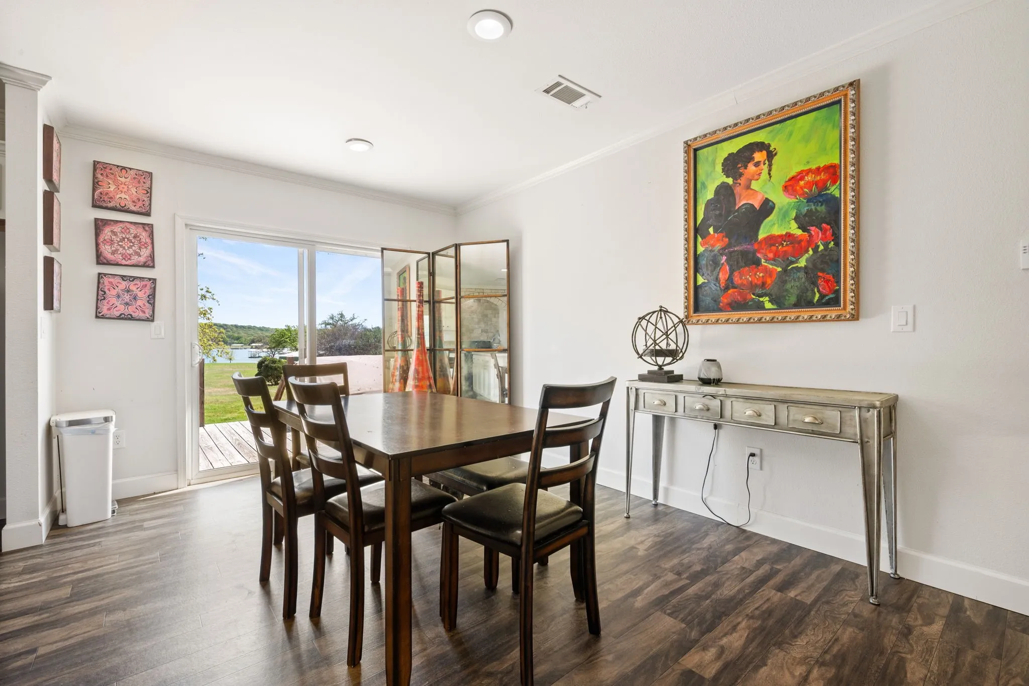 Dining room featuring ornamental molding and dark wood-style floors