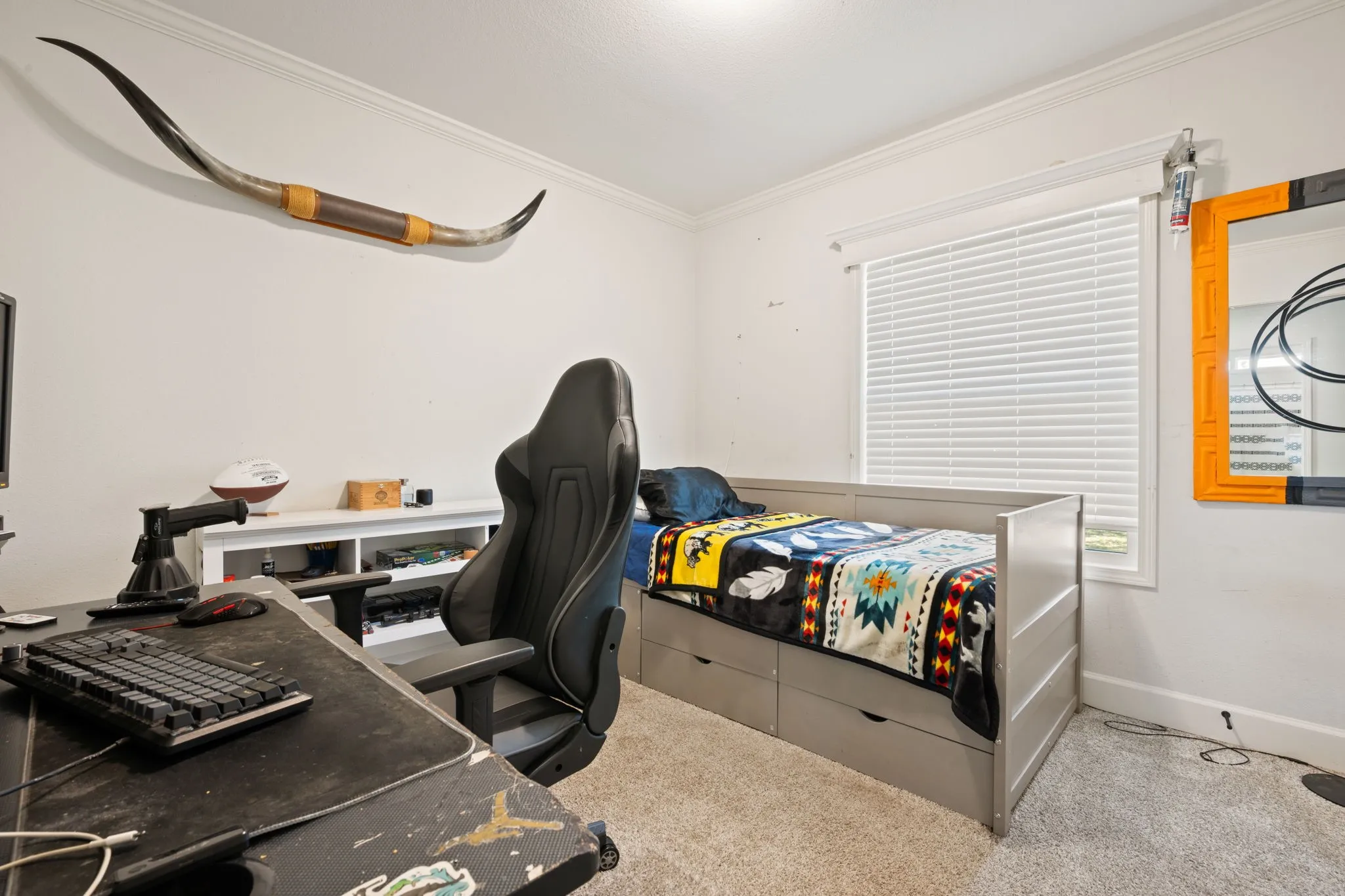 Carpeted bedroom featuring a desk and ornamental molding