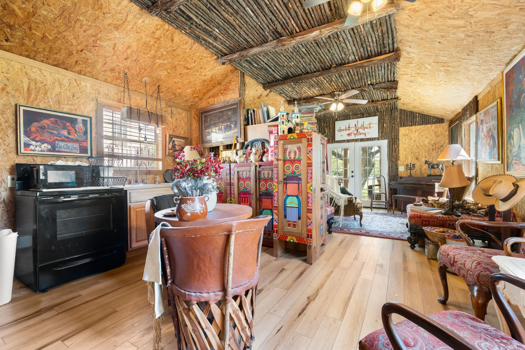 Dining room with light wood-style flooring, french doors, vaulted ceiling, and ceiling fan