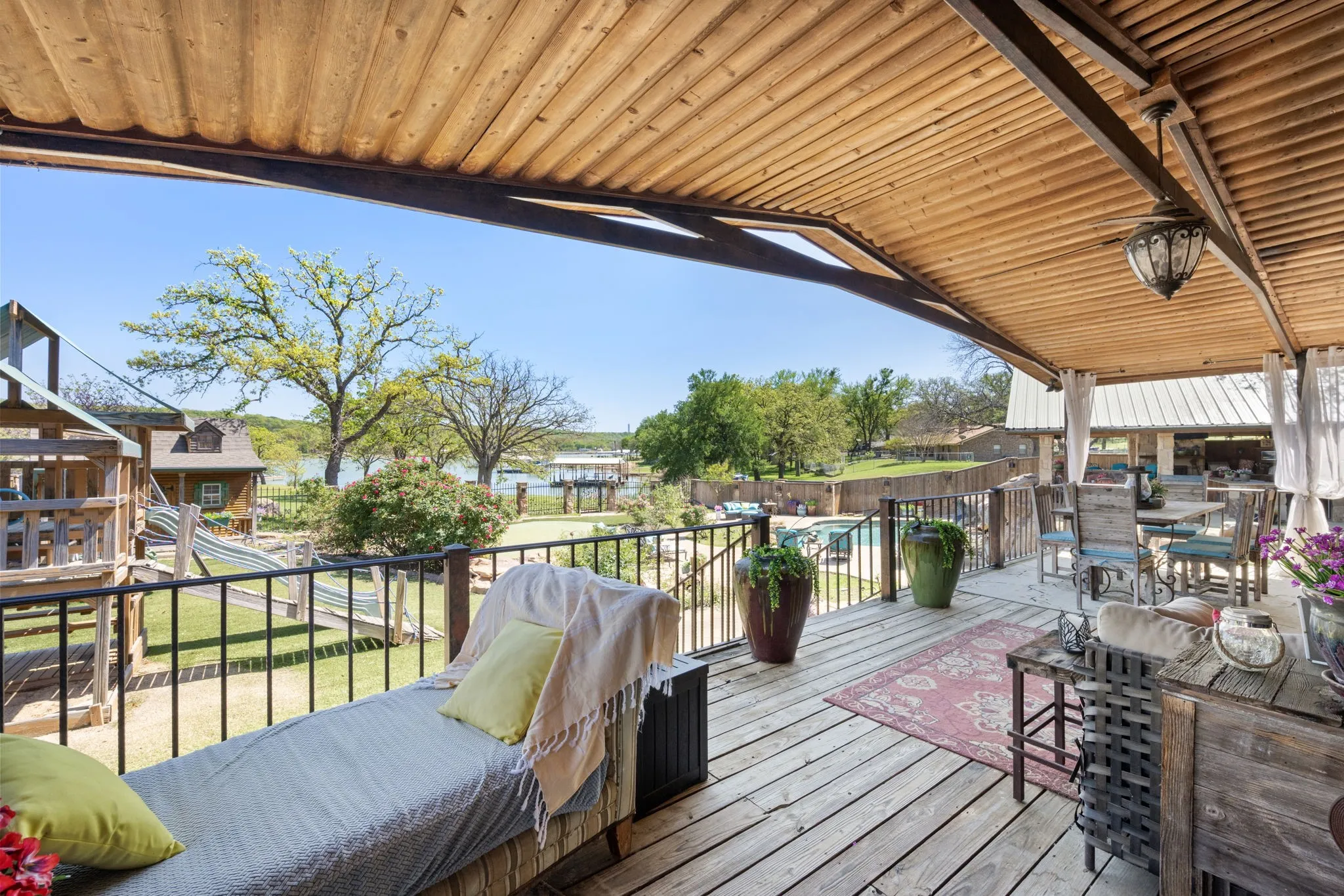 Wooden deck featuring outdoor dining area and a grill