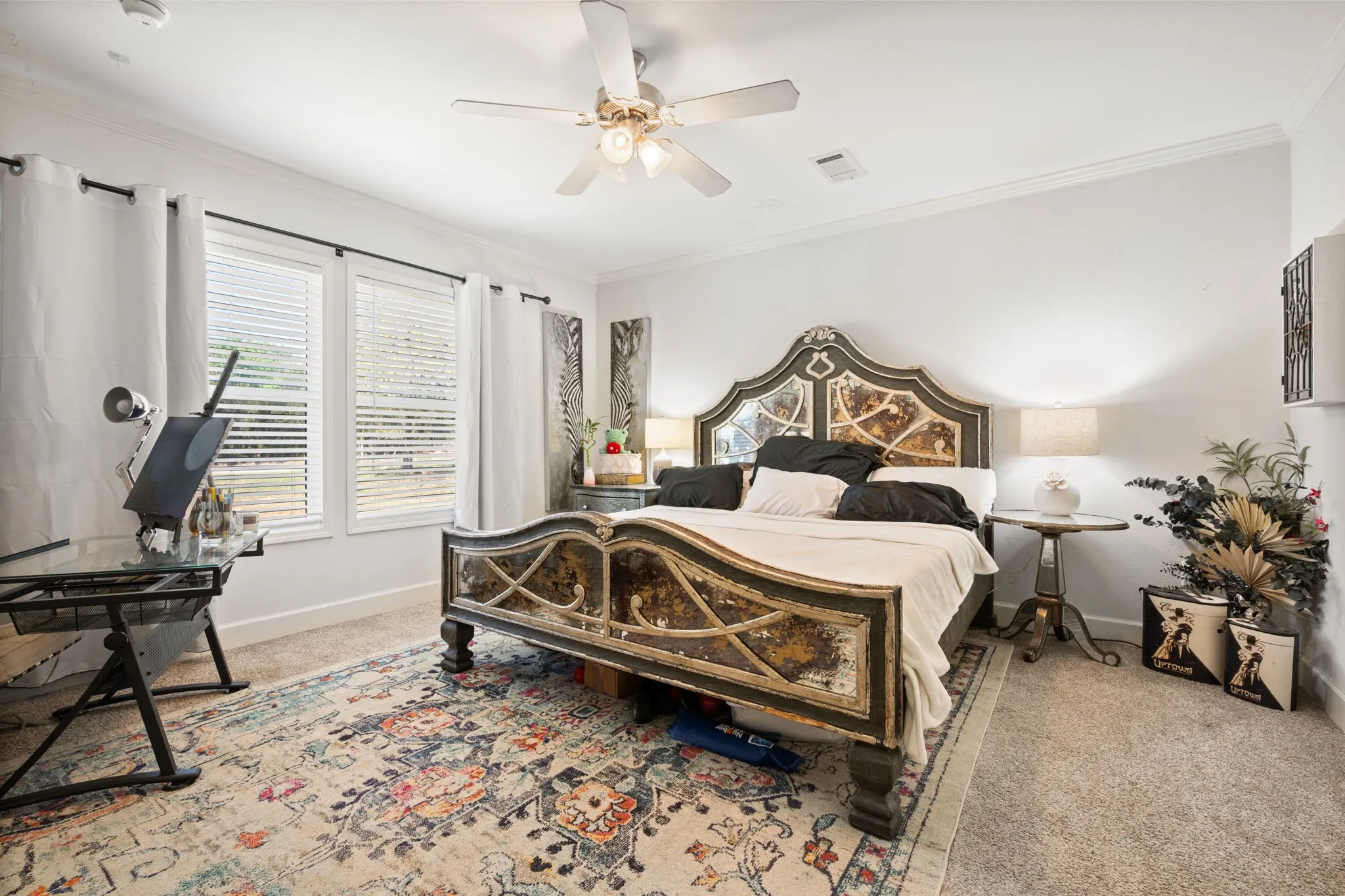 Bedroom with carpet floors, ornamental molding, and ceiling fan