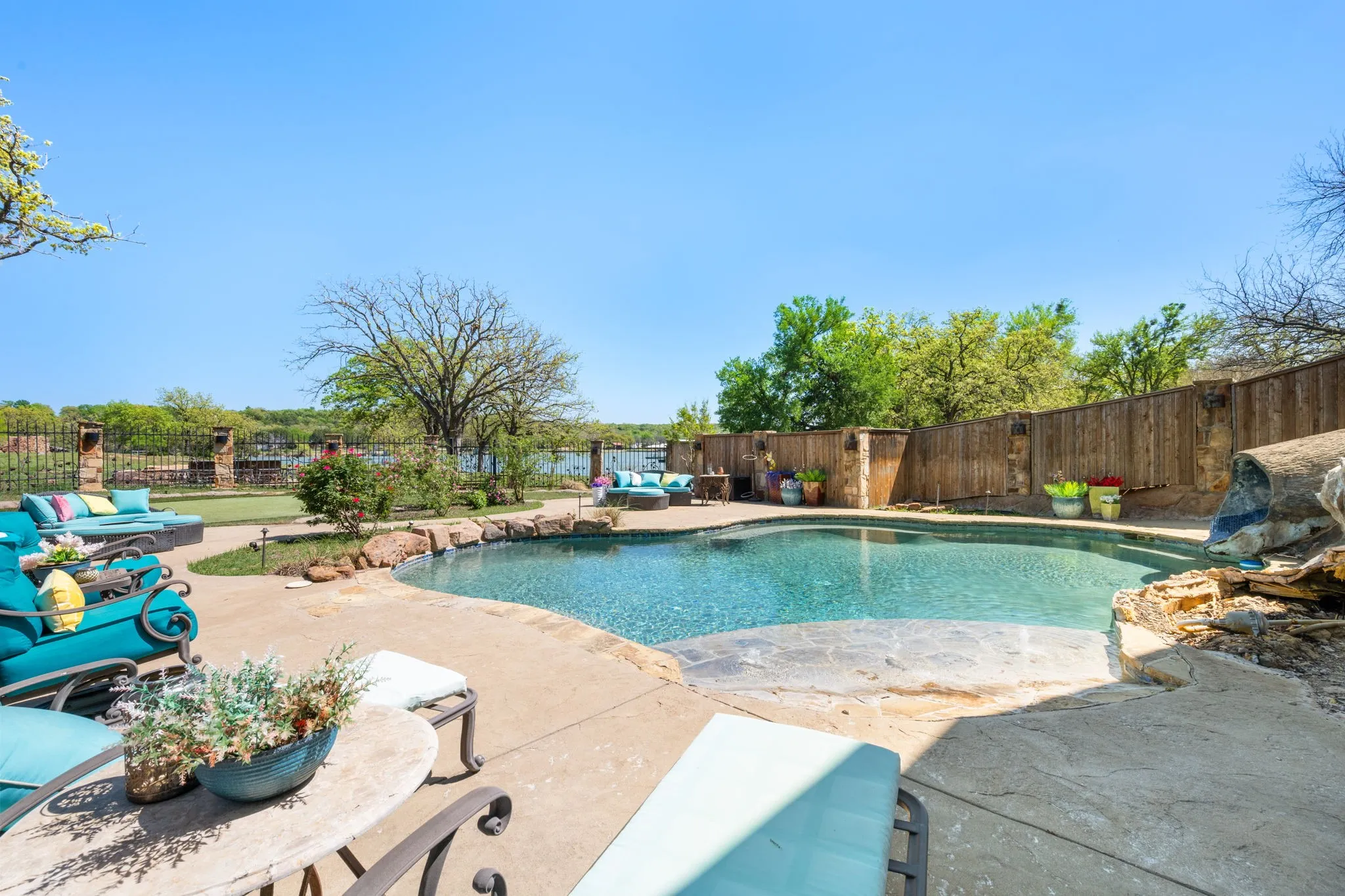 View of pool featuring patio surround and a fenced backyard