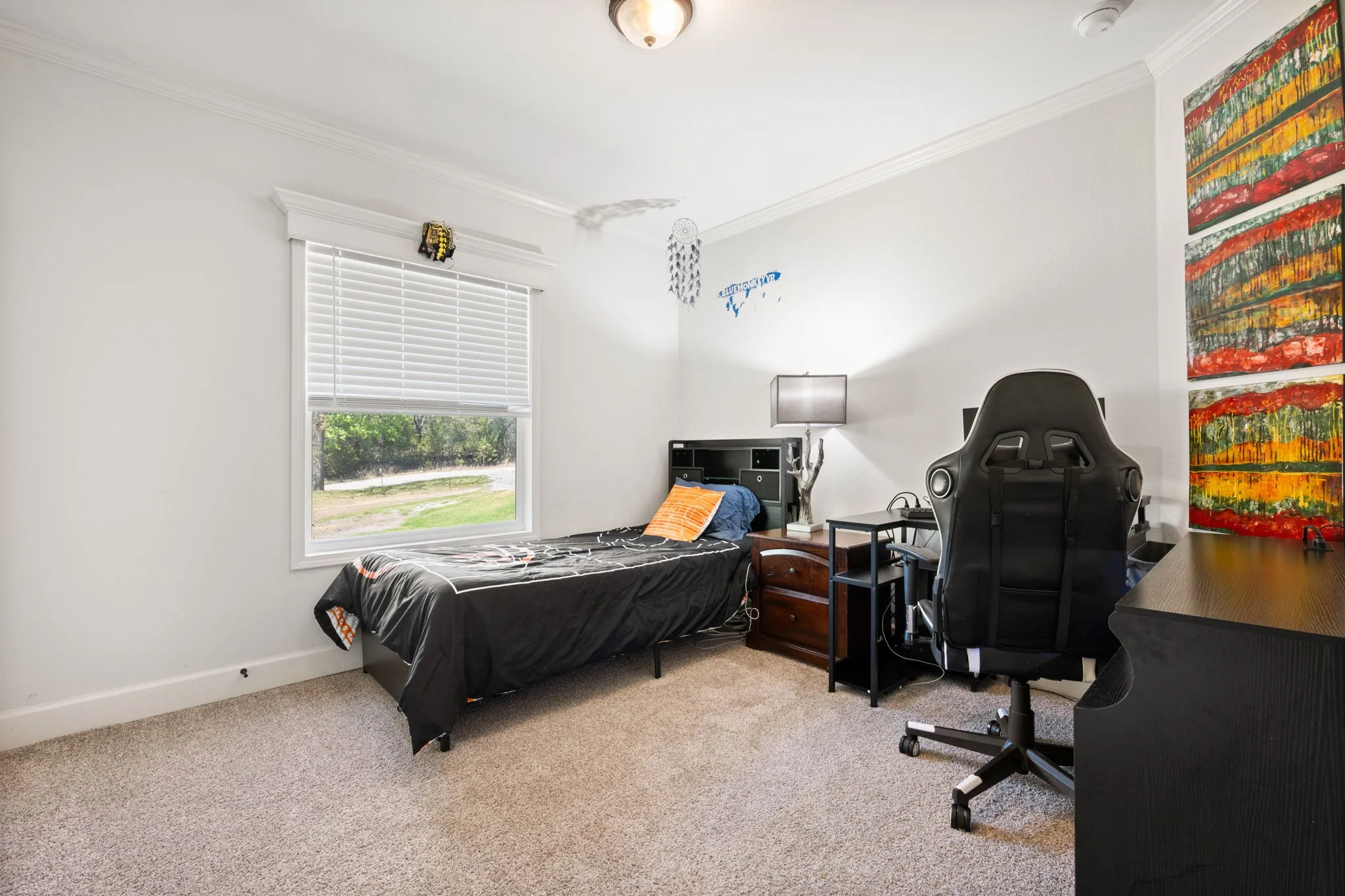 Bedroom featuring light colored carpet, crown molding, and an office area