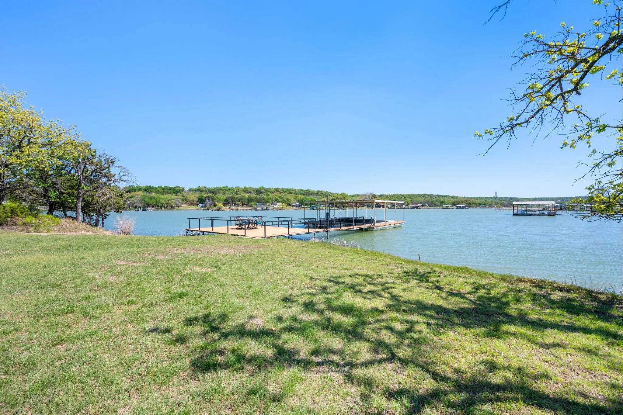 Dock area with a yard and a water view