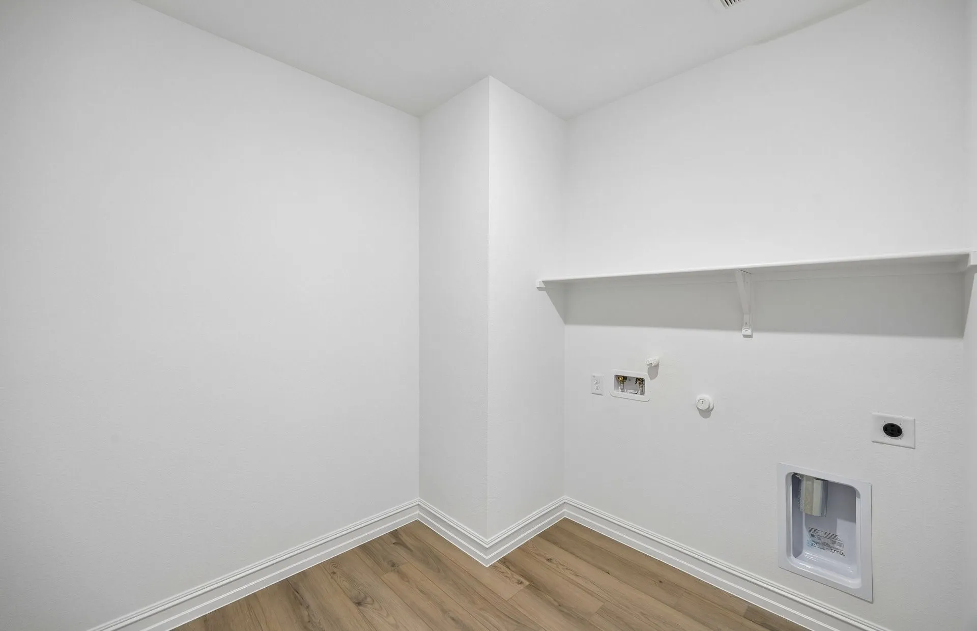 Laundry room with built-in shelving