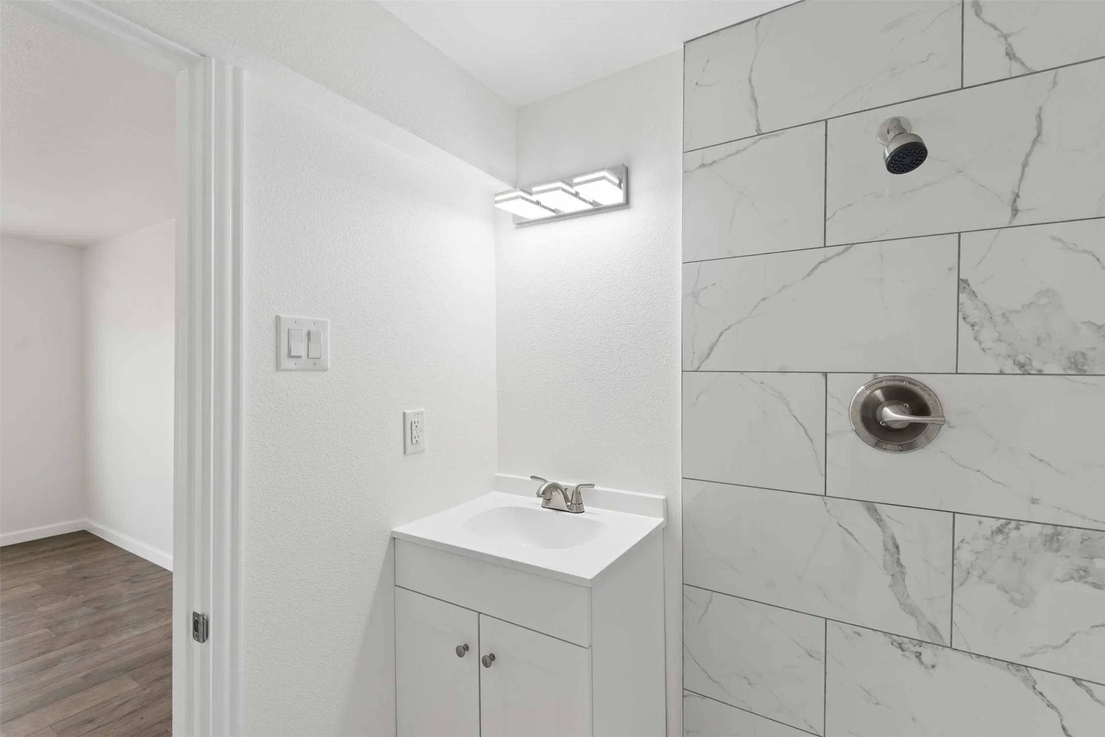 Bathroom featuring vanity and a tile shower