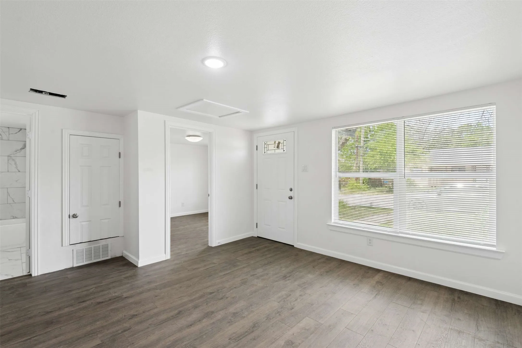 Foyer featuring baseboards and dark wood-style flooring