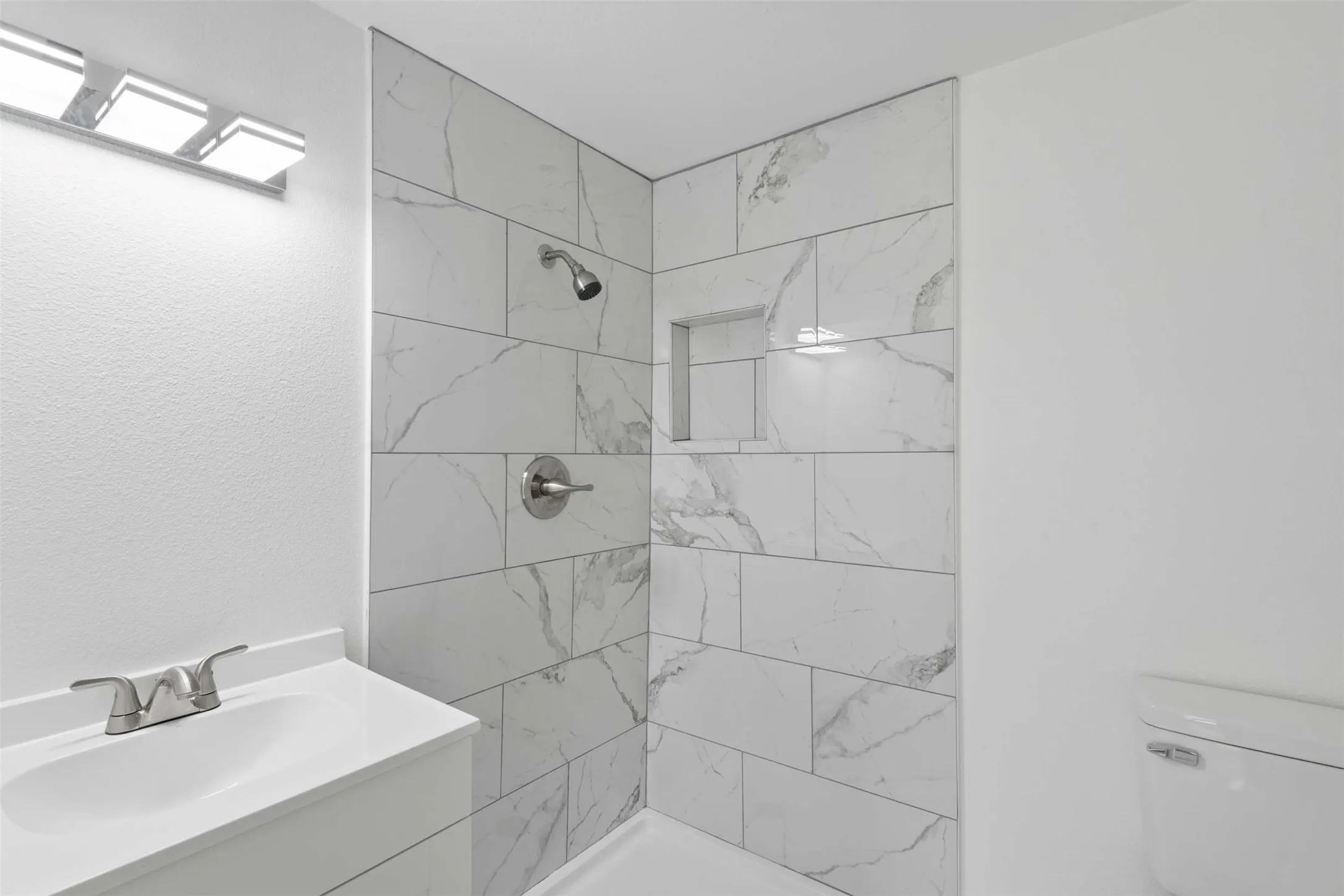 Bathroom with vanity and a shower stall