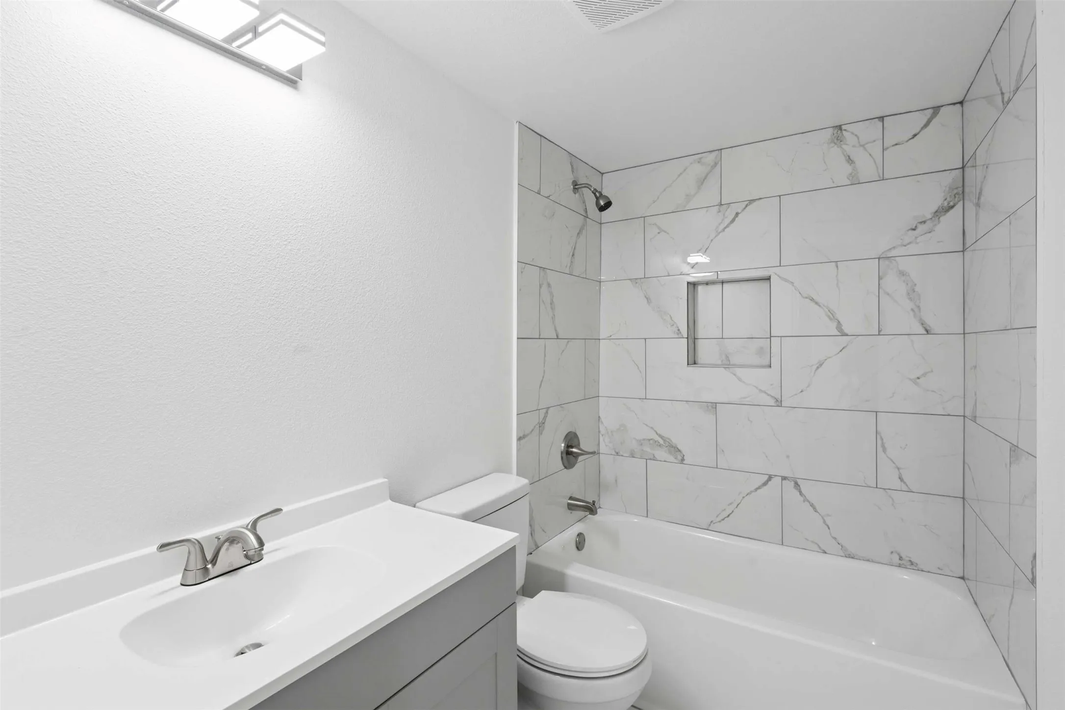 Bathroom with vanity and shower / tub combination