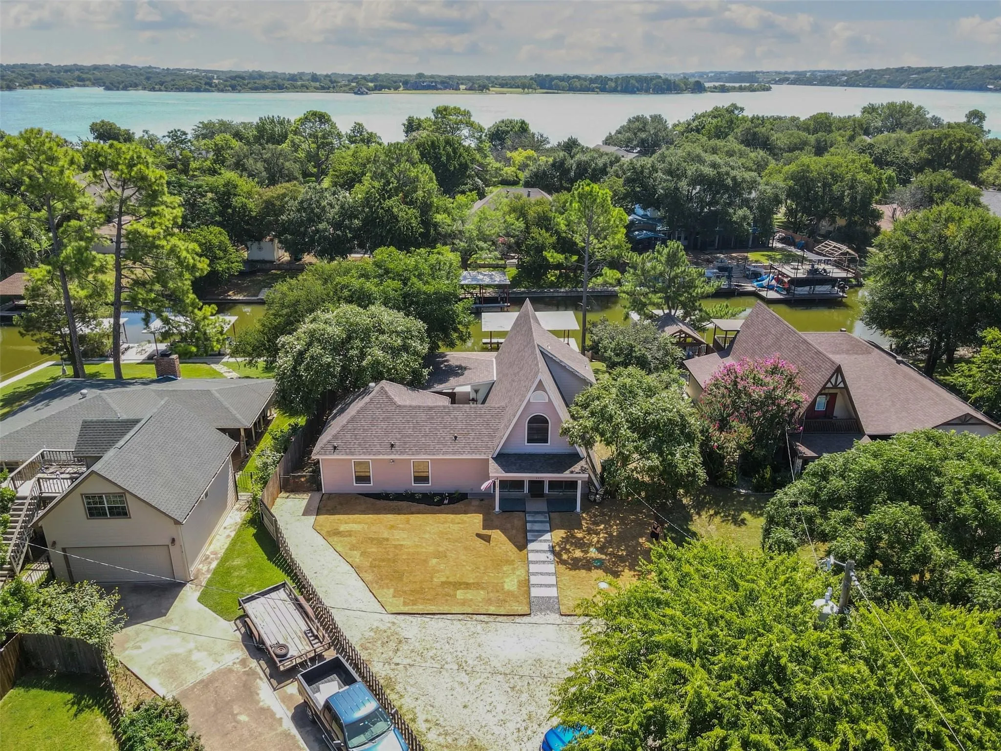Aerial perspective of suburban area featuring a nearby body of water