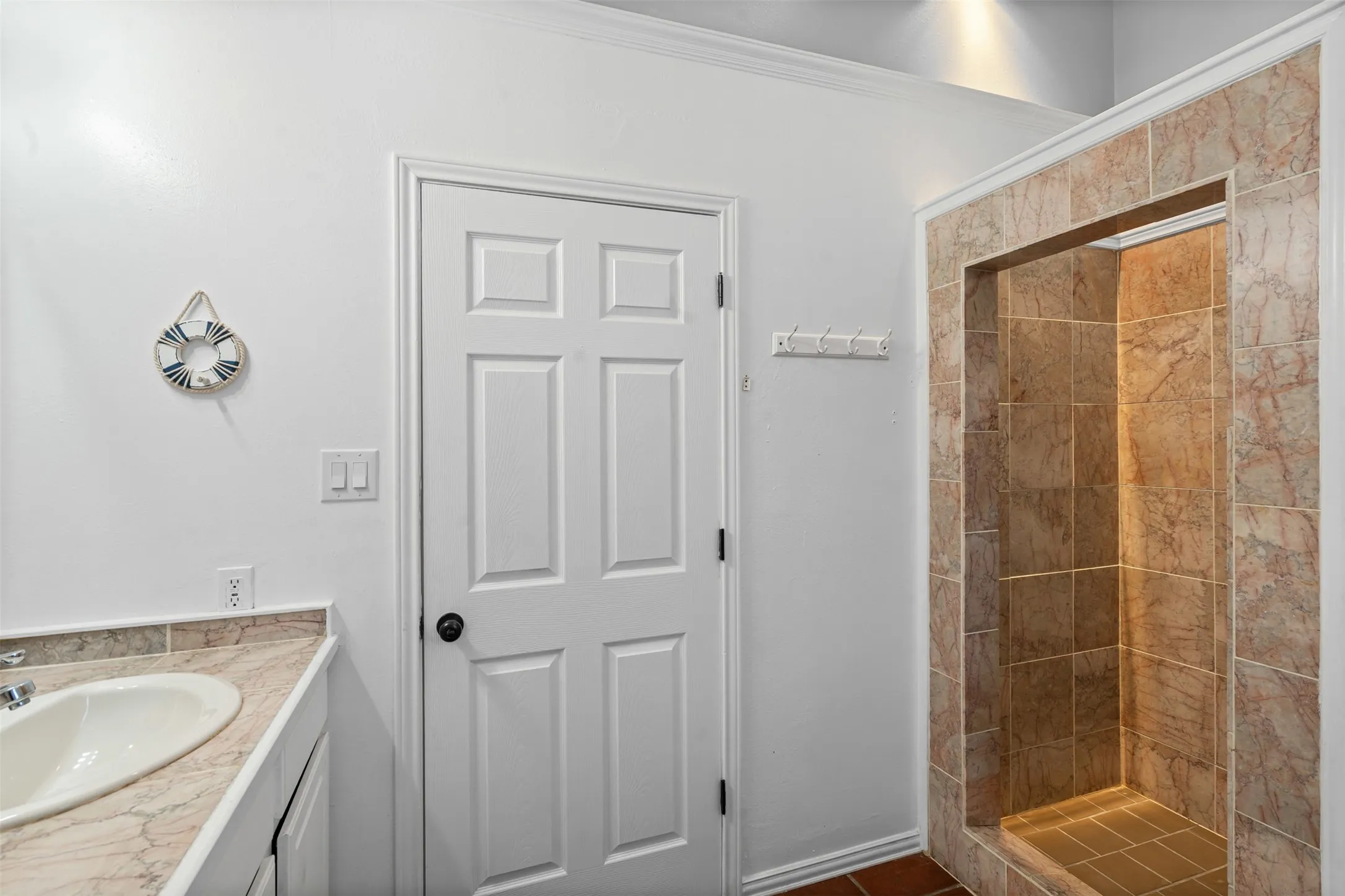 Bathroom featuring vanity and a shower stall