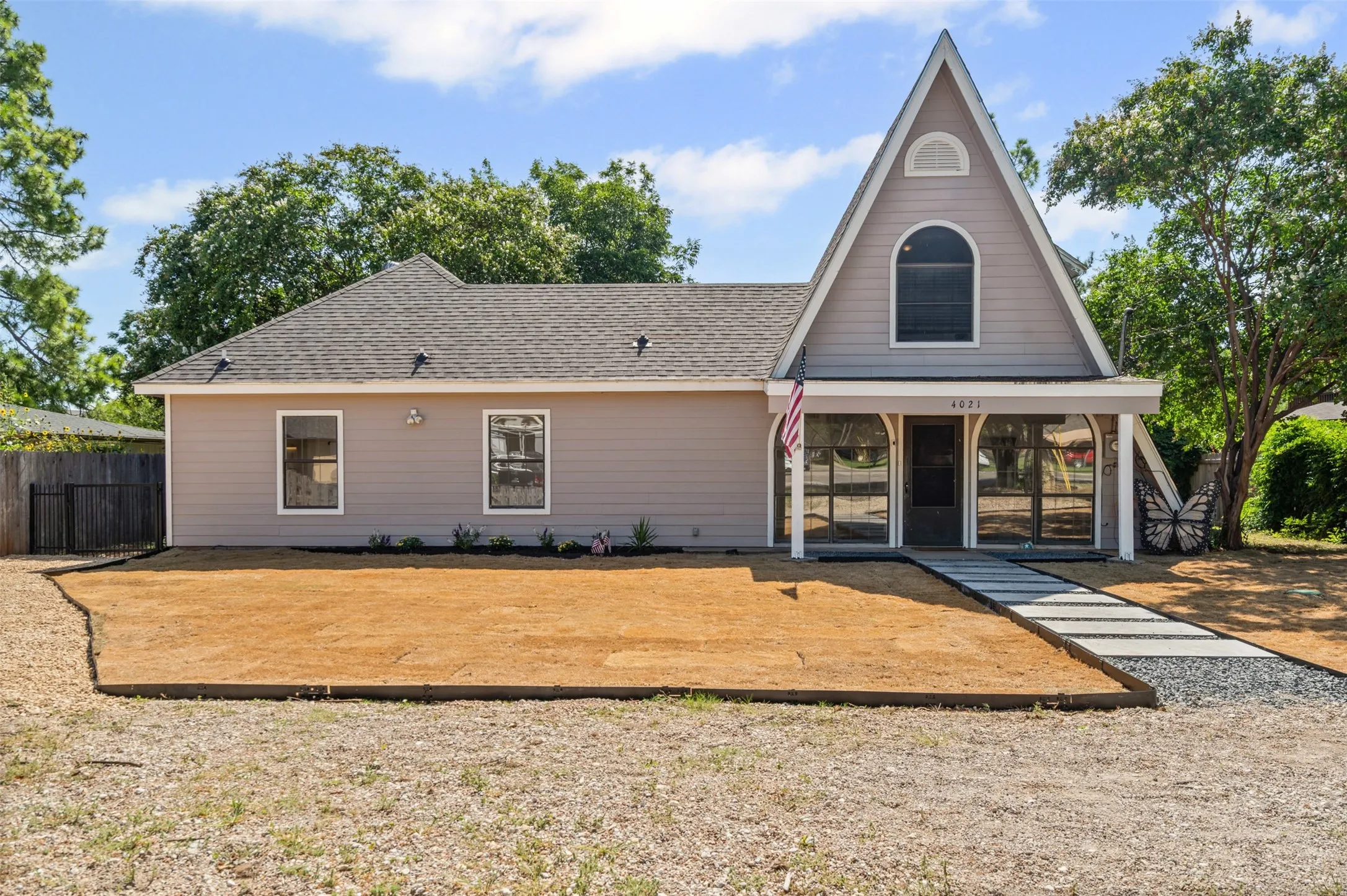 View of front of home featuring roof with shingles and covered porch