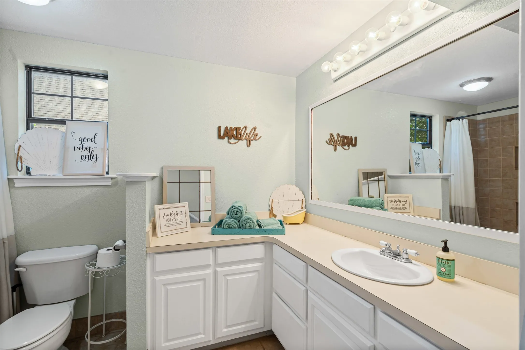 Bathroom featuring vanity and curtained shower