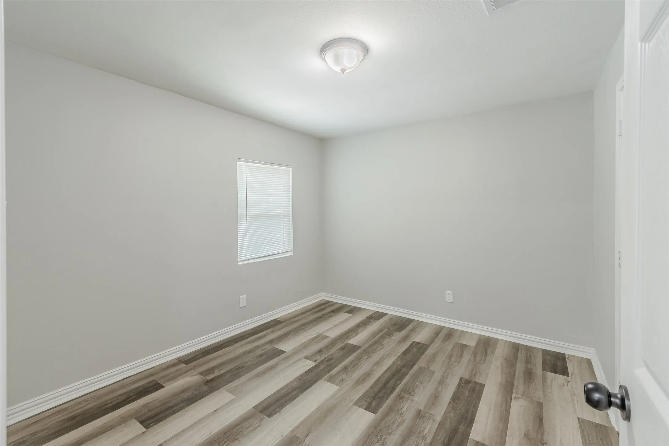 Empty room featuring light wood-style floors and baseboards