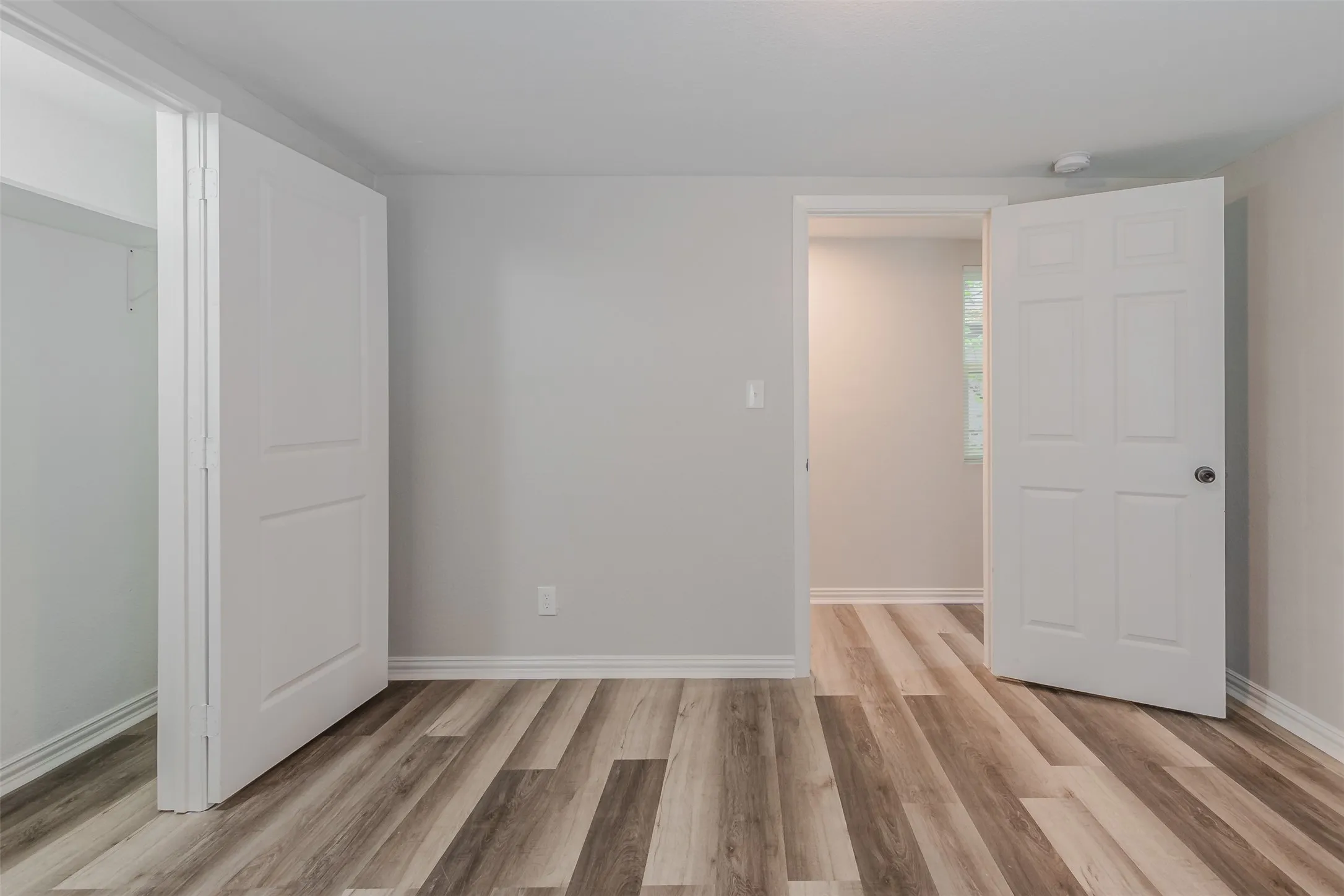 Unfurnished bedroom with light wood-type flooring and baseboards