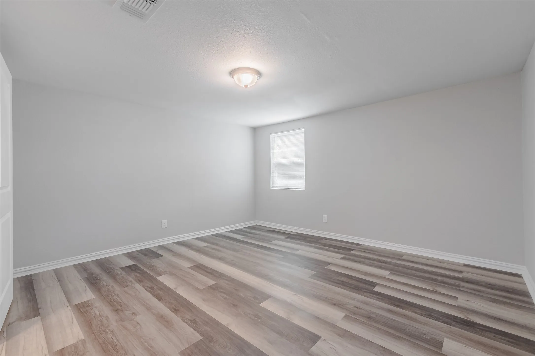 Unfurnished room with light wood-type flooring