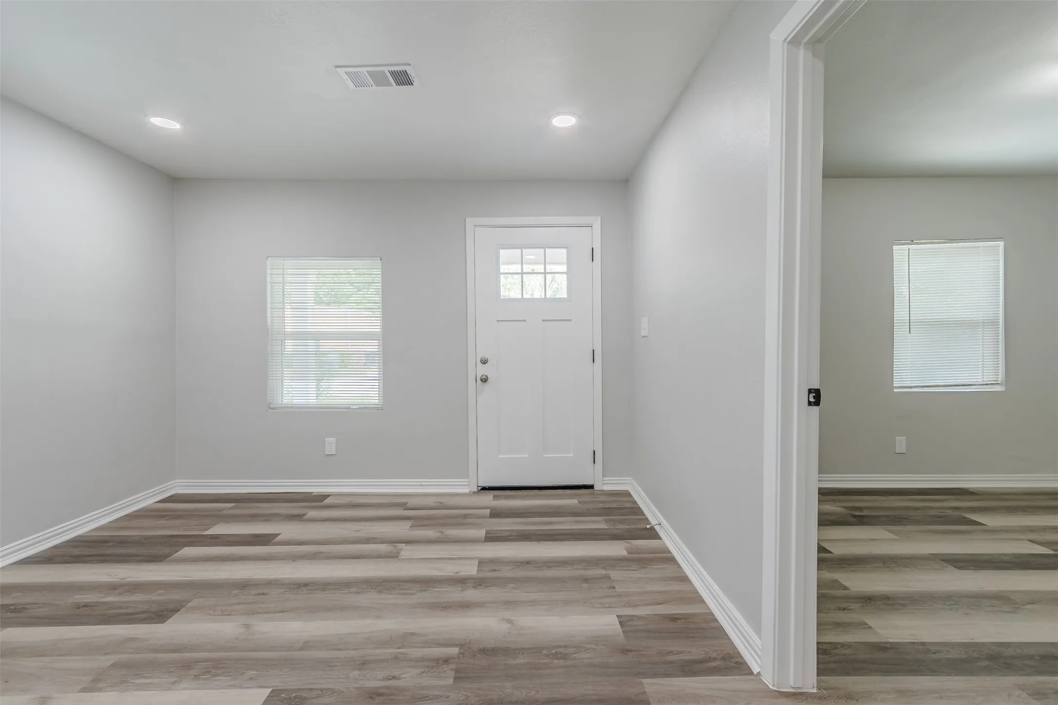 Entryway featuring light wood-style flooring and recessed lighting