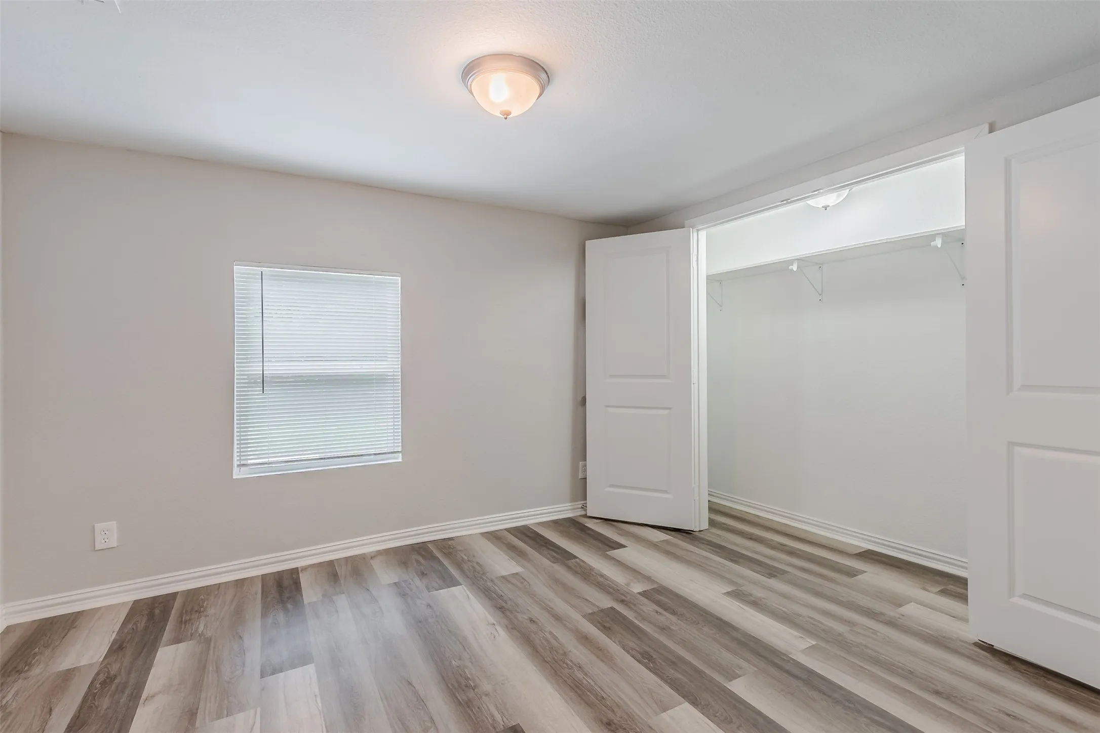 Unfurnished bedroom with a closet and light wood-type flooring