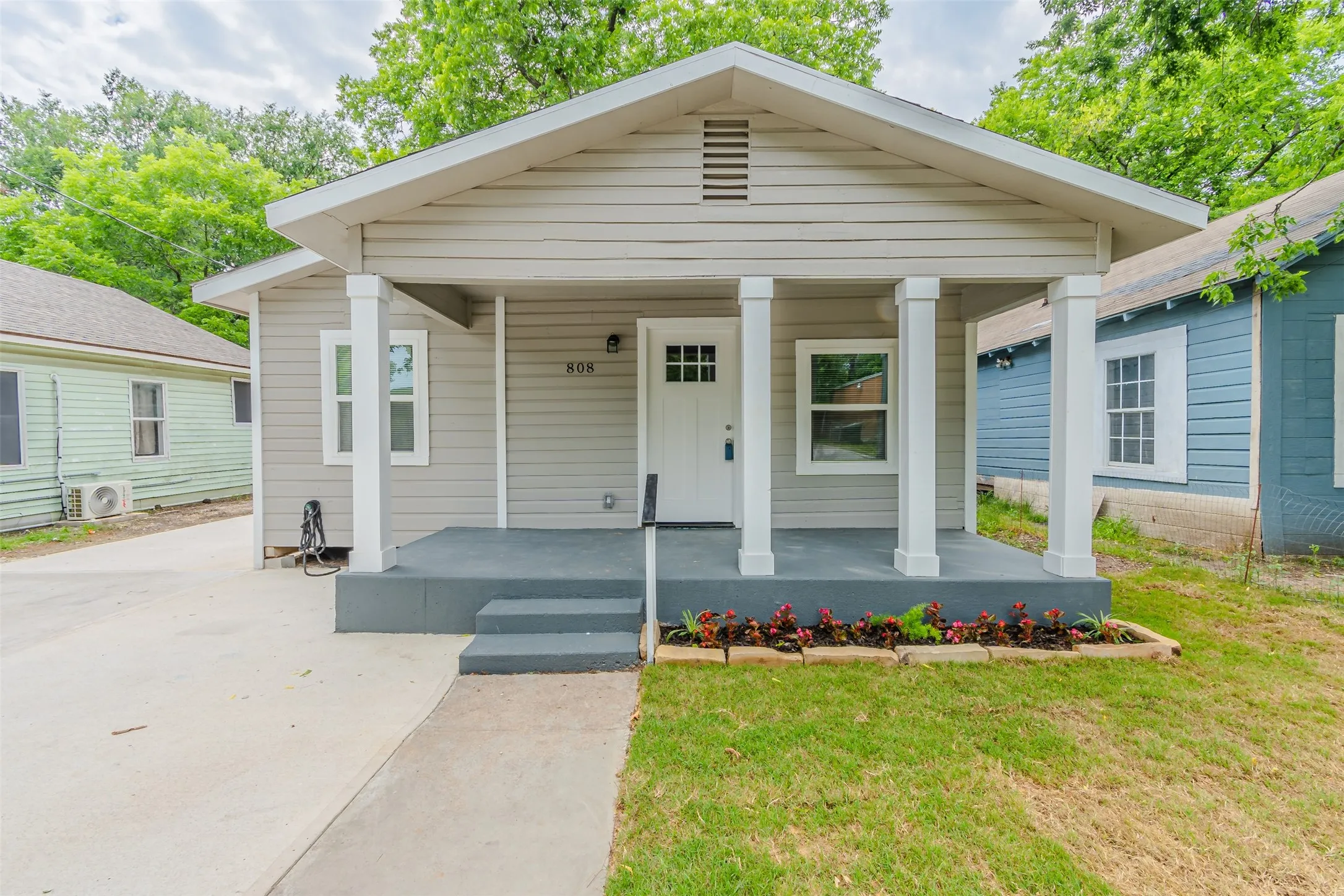 View of front of property with covered porch and a front lawn