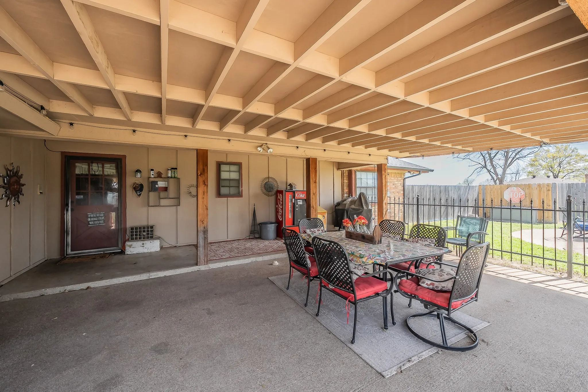 Covered patio in back yard overlooking the pool and acreage