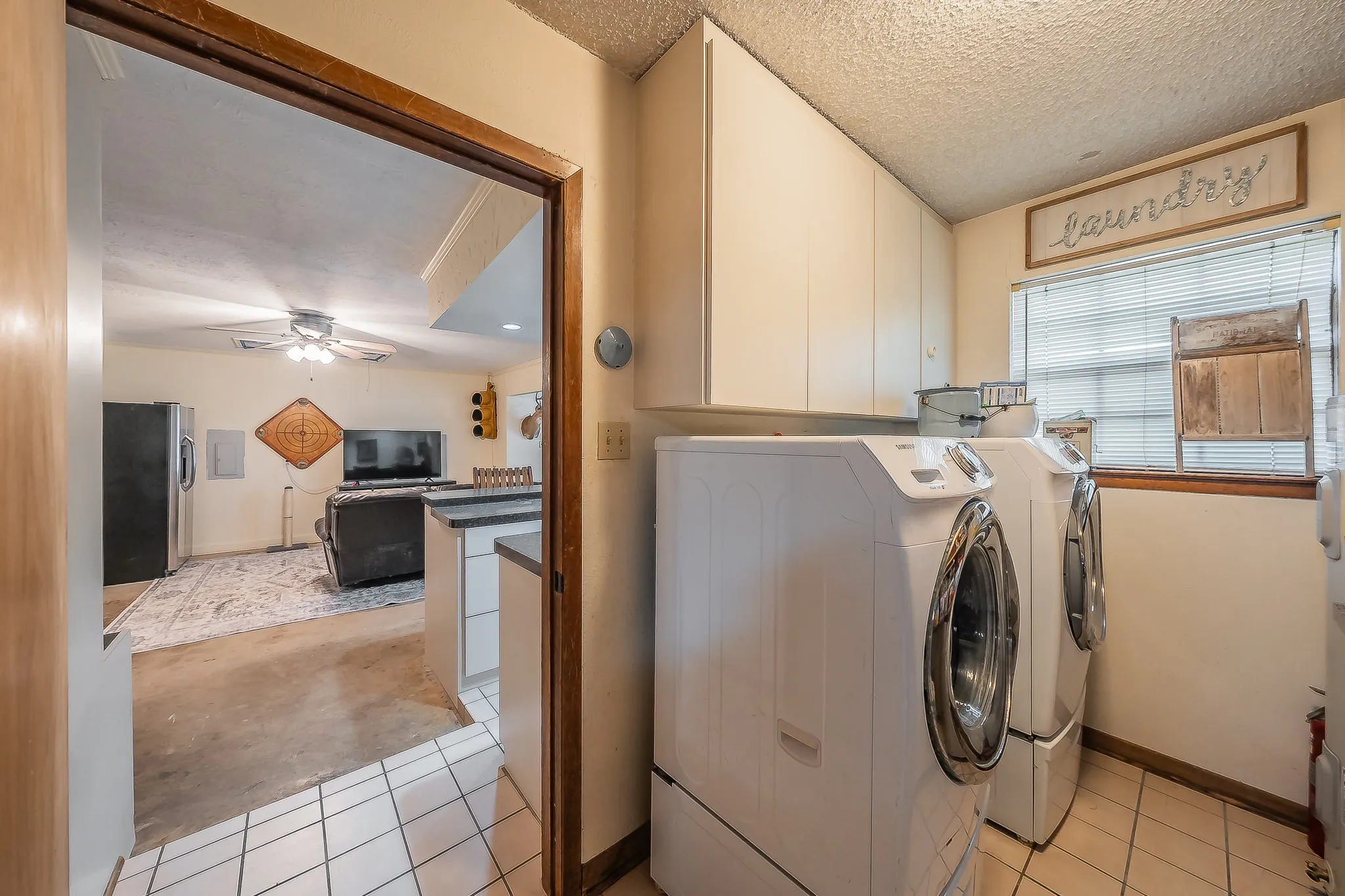 Laundry room with wall of shelves for pantry