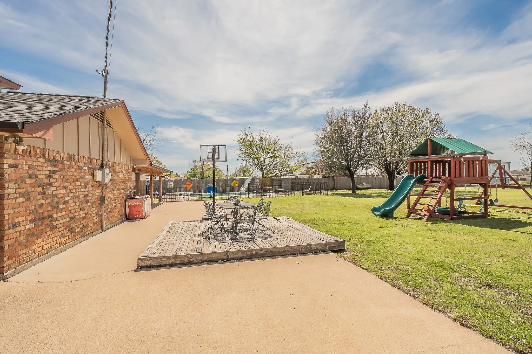 Extended Patio area for entertaining, basketball, chairs, firepit