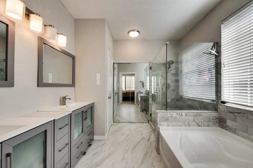 Bathroom featuring vanity, a textured ceiling, and shower with separate bathtub