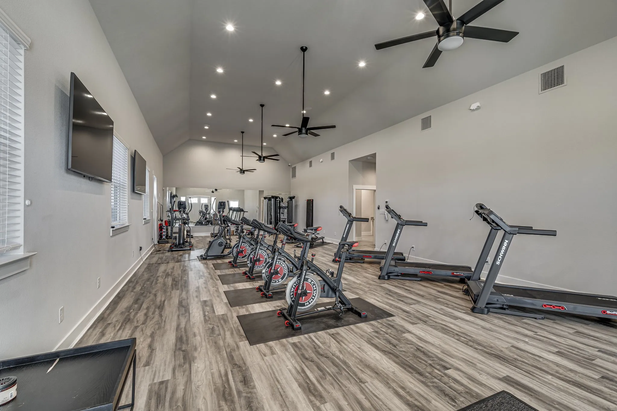 Workout area with vaulted ceiling, ceiling fan, and recessed lighting