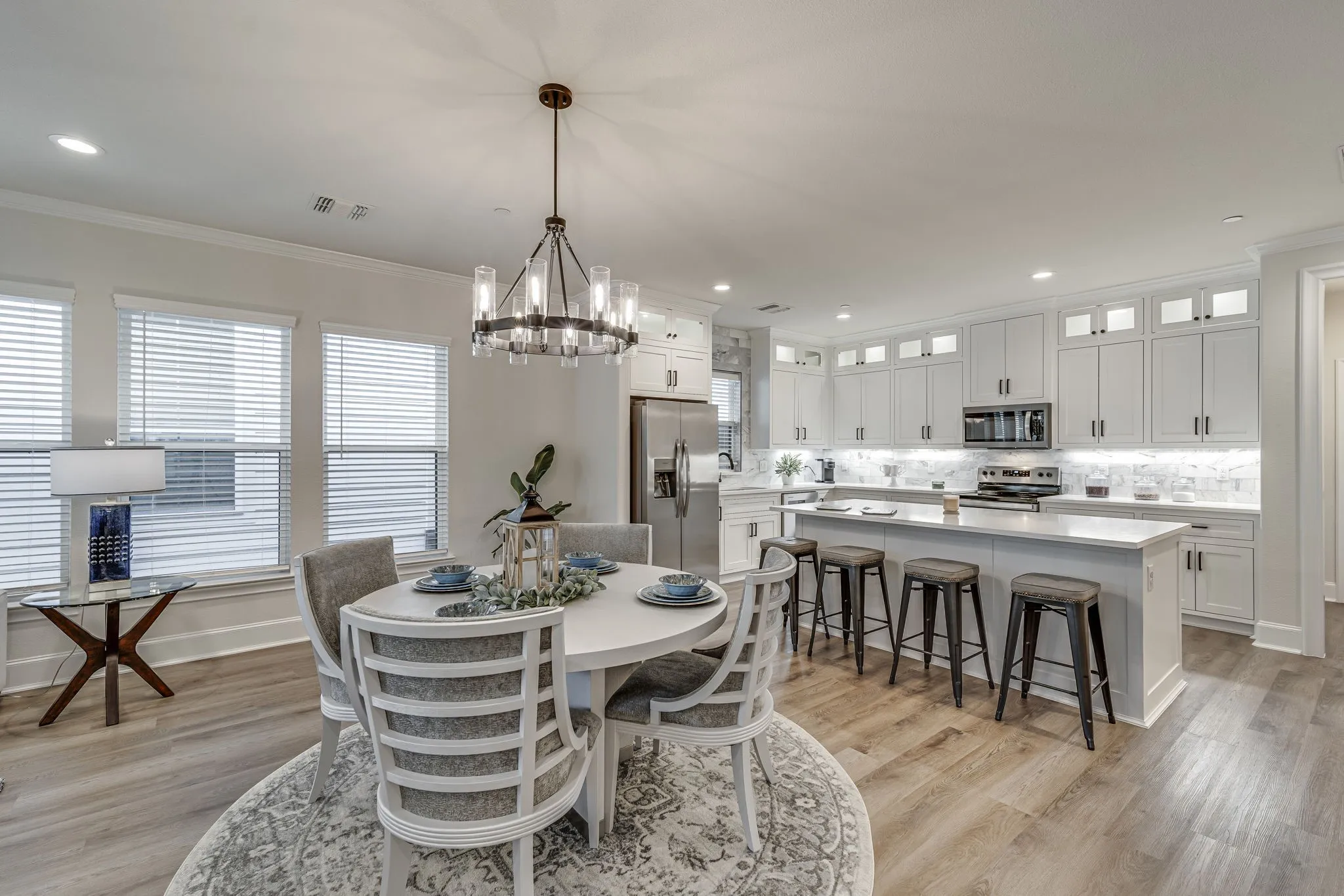 Dining area featuring suspended lighting, light wood-type flooring, and ornamental molding