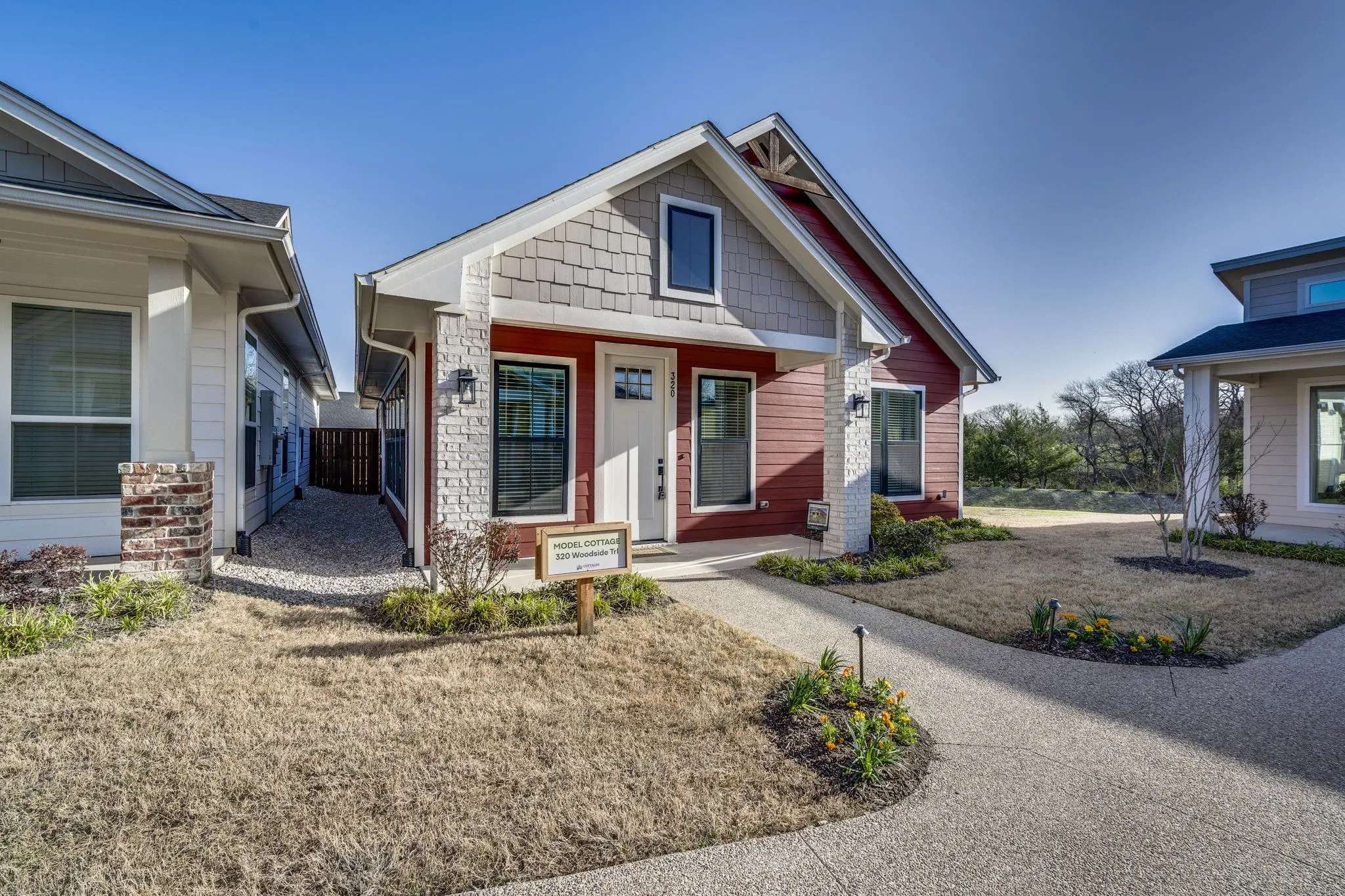 View of front facade with covered porch and stone siding