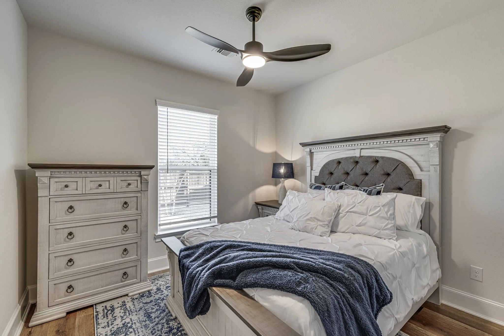Bedroom featuring wood finished floors and ceiling fan