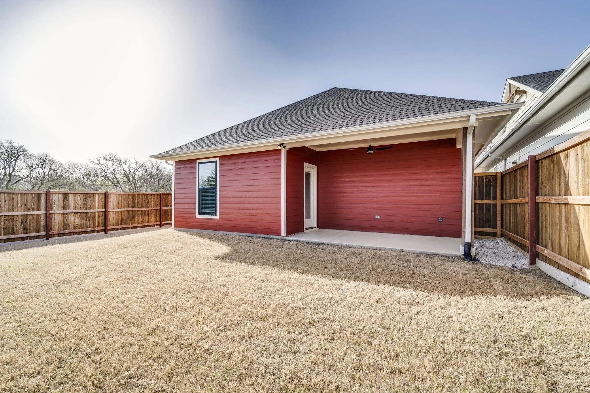 Rear view of property featuring a patio area, roof with shingles, a fenced backyard, and ceiling fan