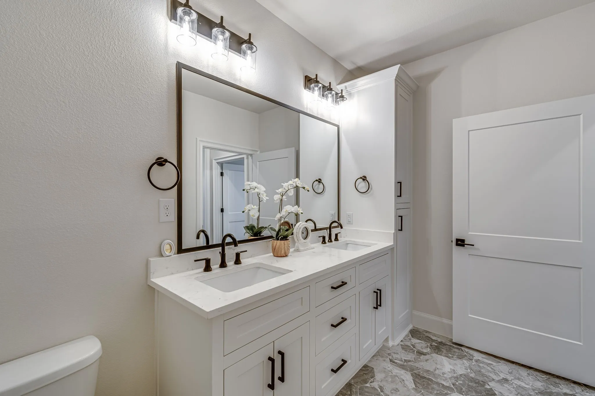 Bathroom featuring double vanity and toilet