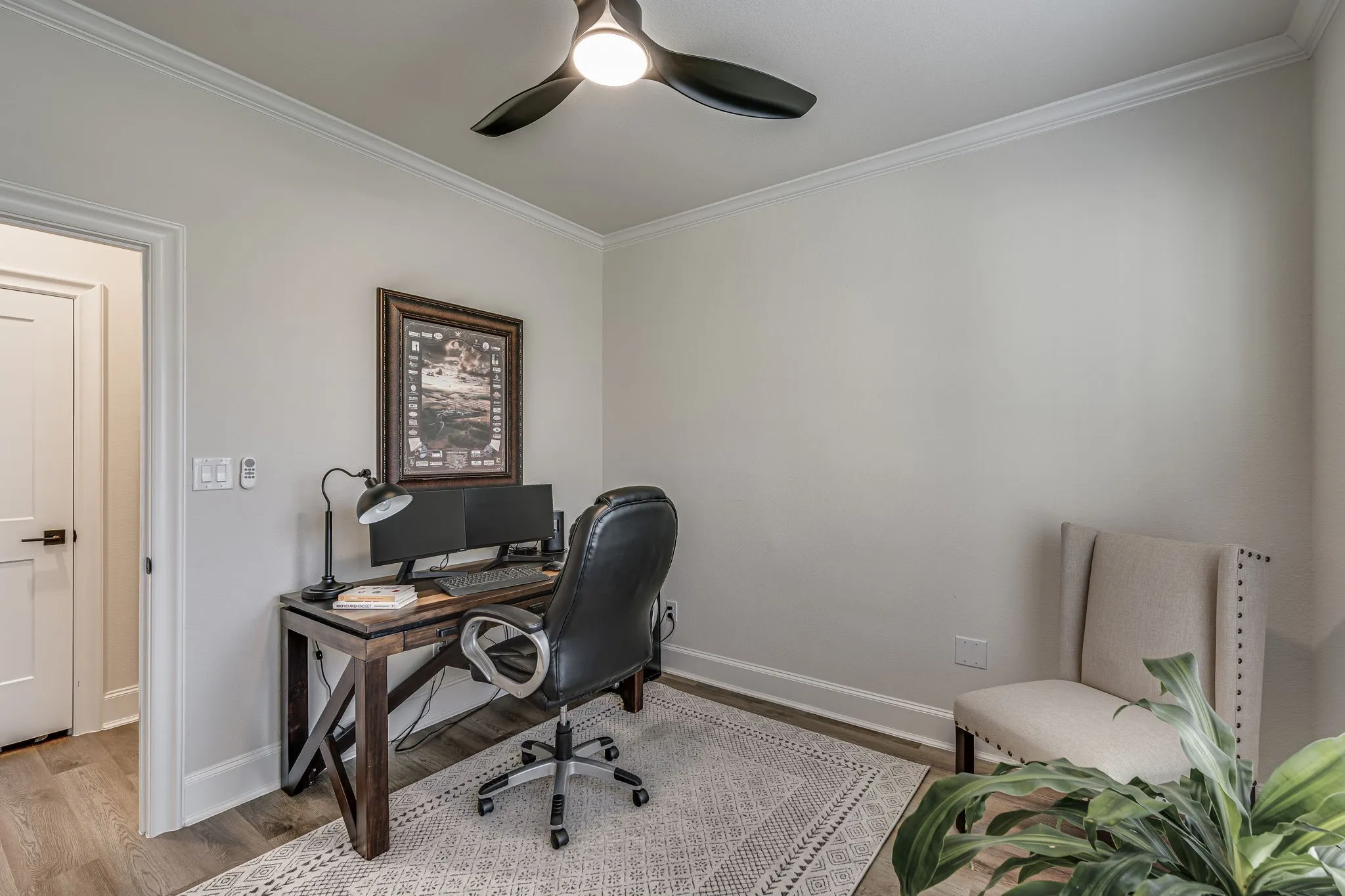 Office area featuring crown molding, a ceiling fan, and light wood-type flooring