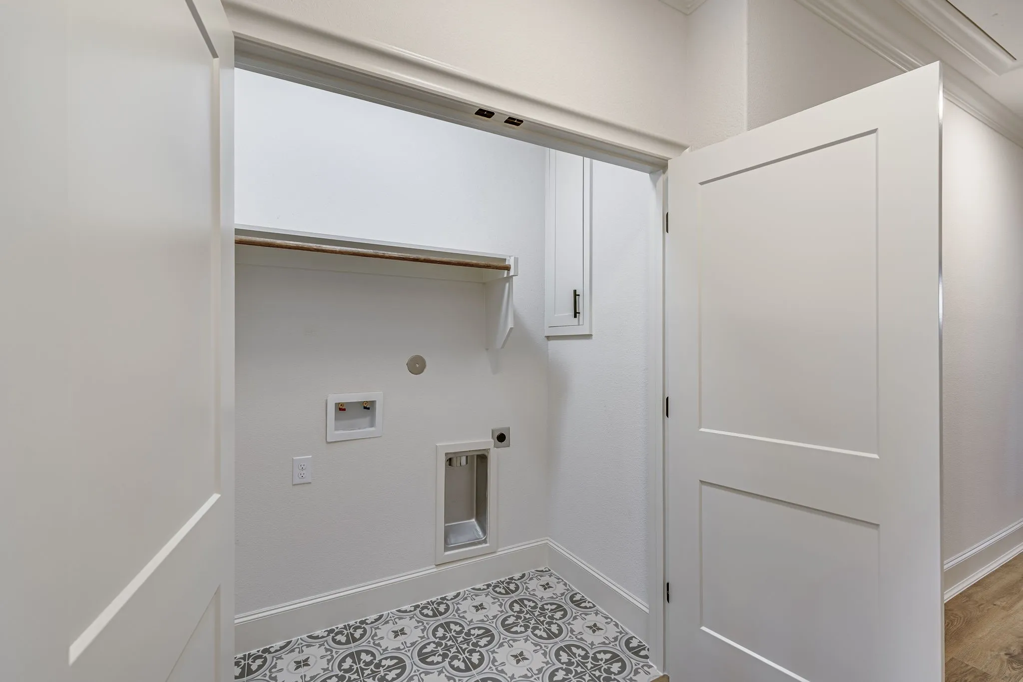 Laundry area featuring electric dryer hookup, hookup for a washing machine, and cabinet space