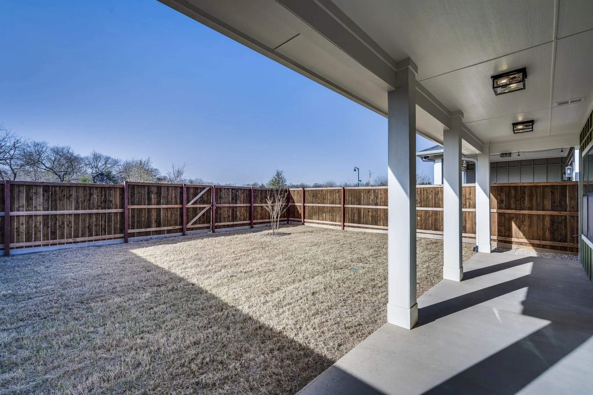 Fenced backyard with a patio
