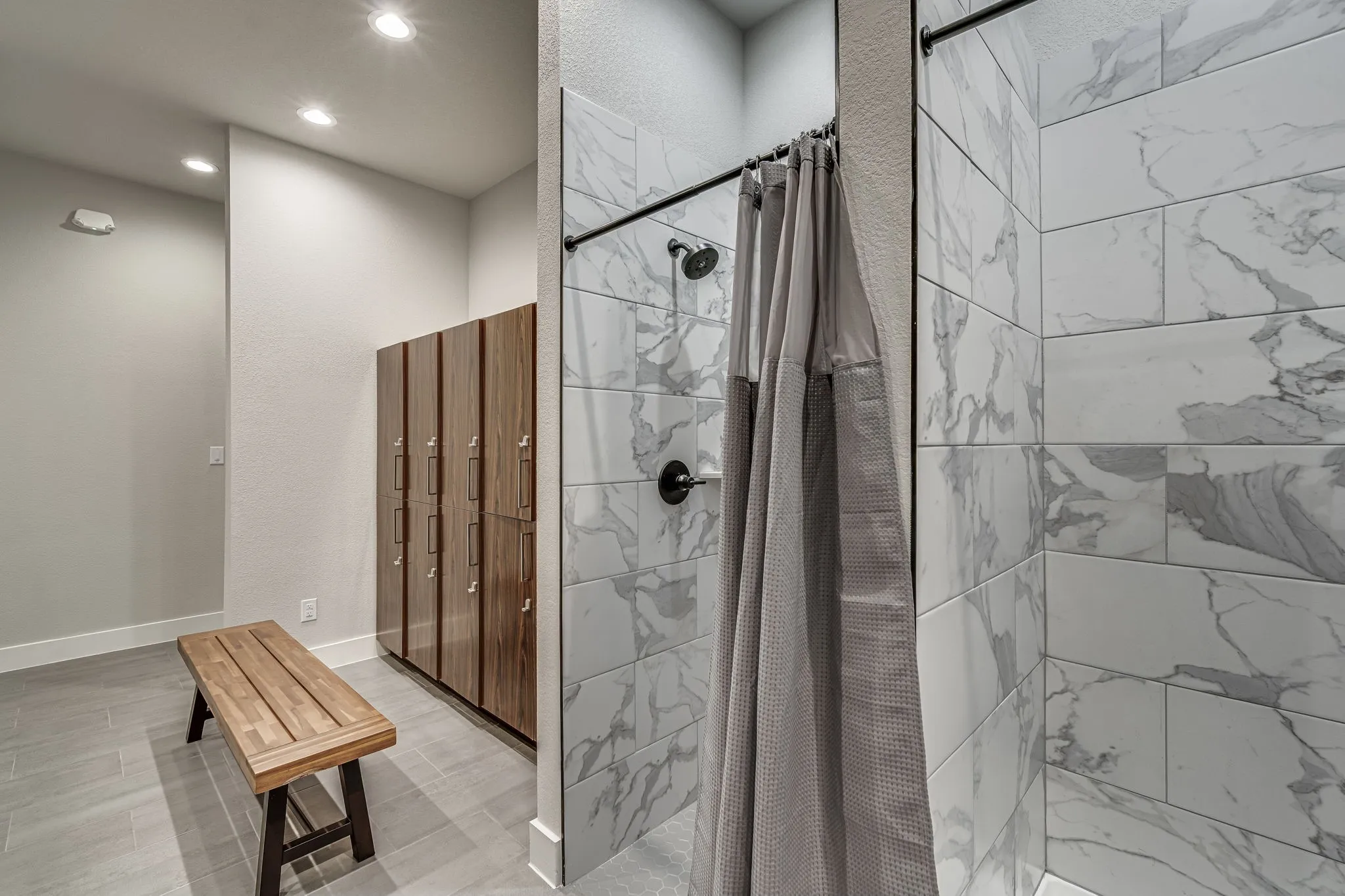 Bathroom with a shower stall, recessed lighting, and a closet