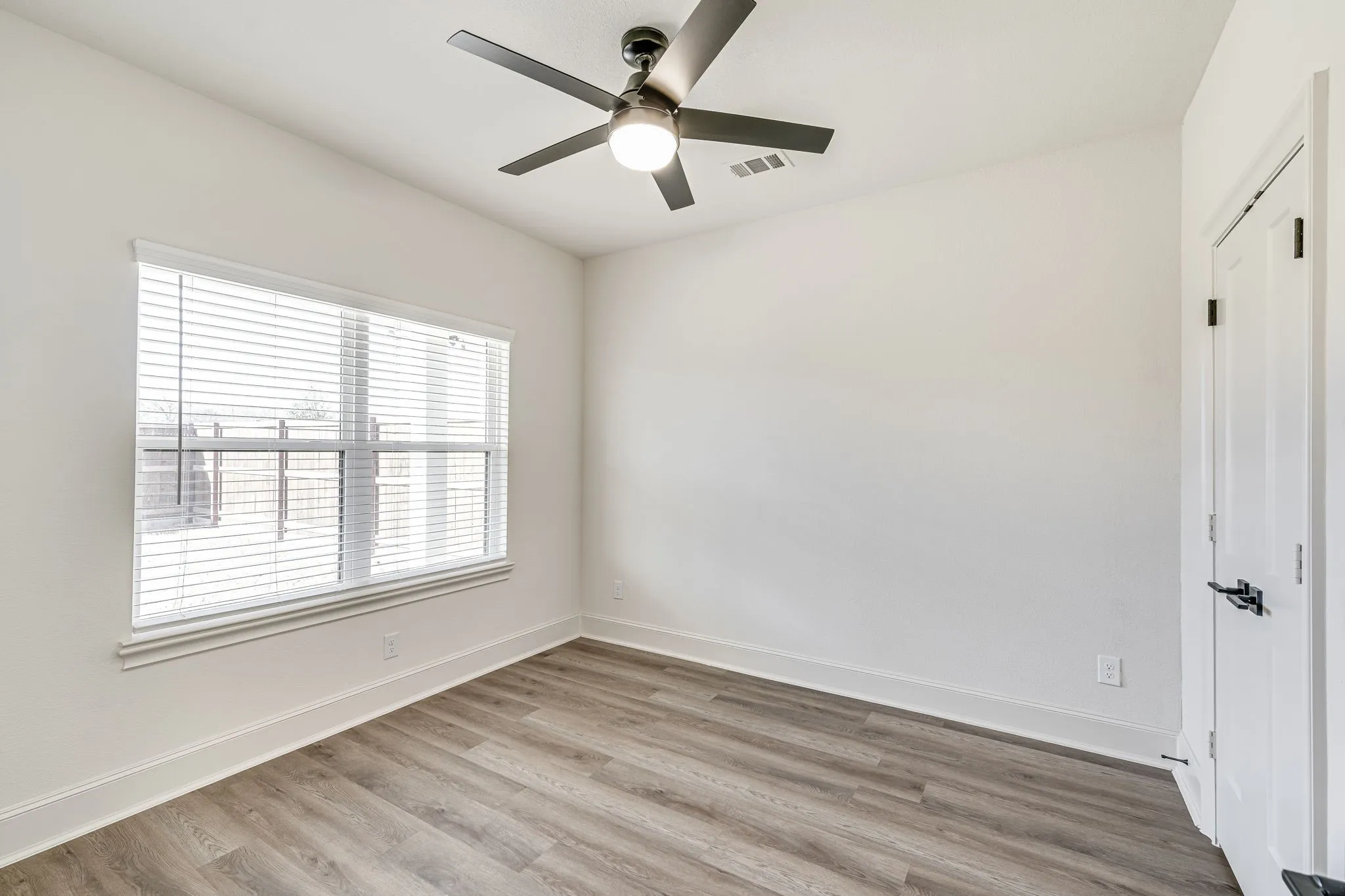 Spare room with light wood-style floors and ceiling fan