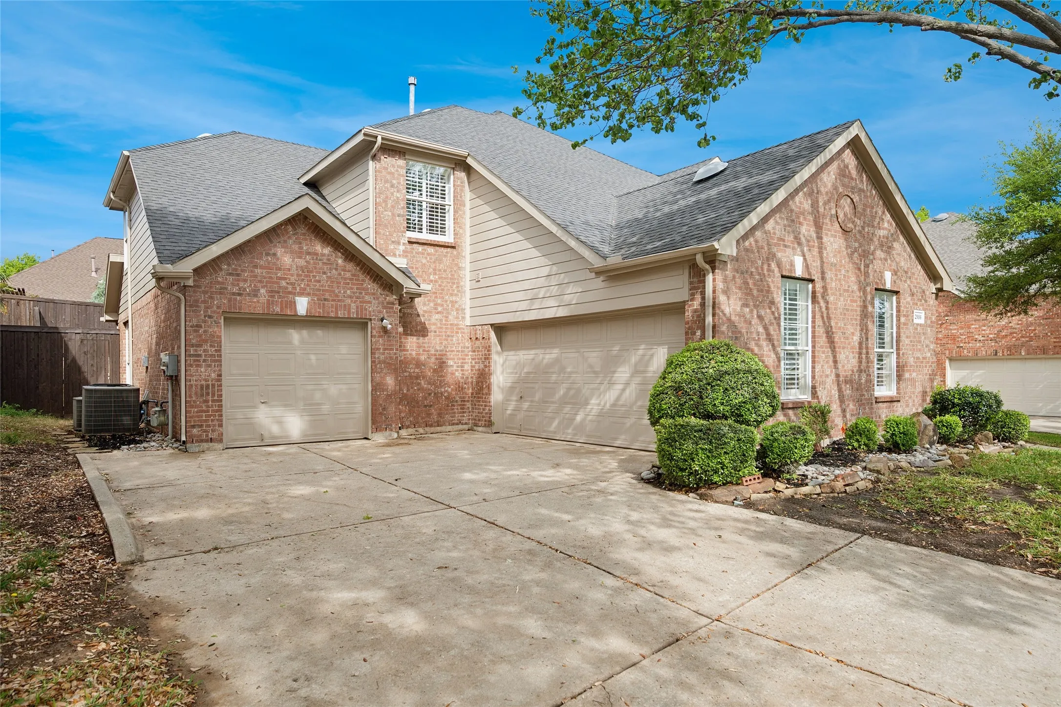 Two car garage plus a single car garage with extra space for a workbench.