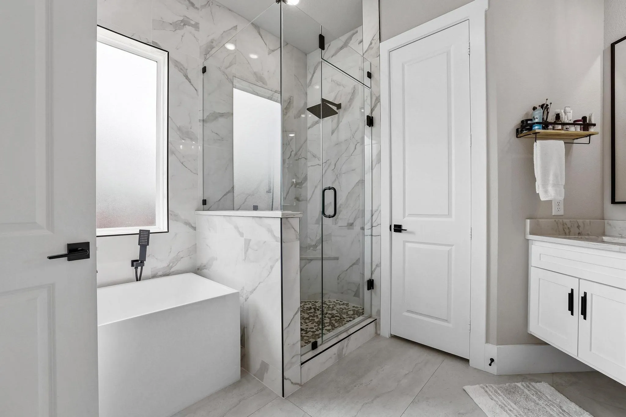 Full bath with a marble finish shower, a soaking tub, vanity, and light marble finish floors