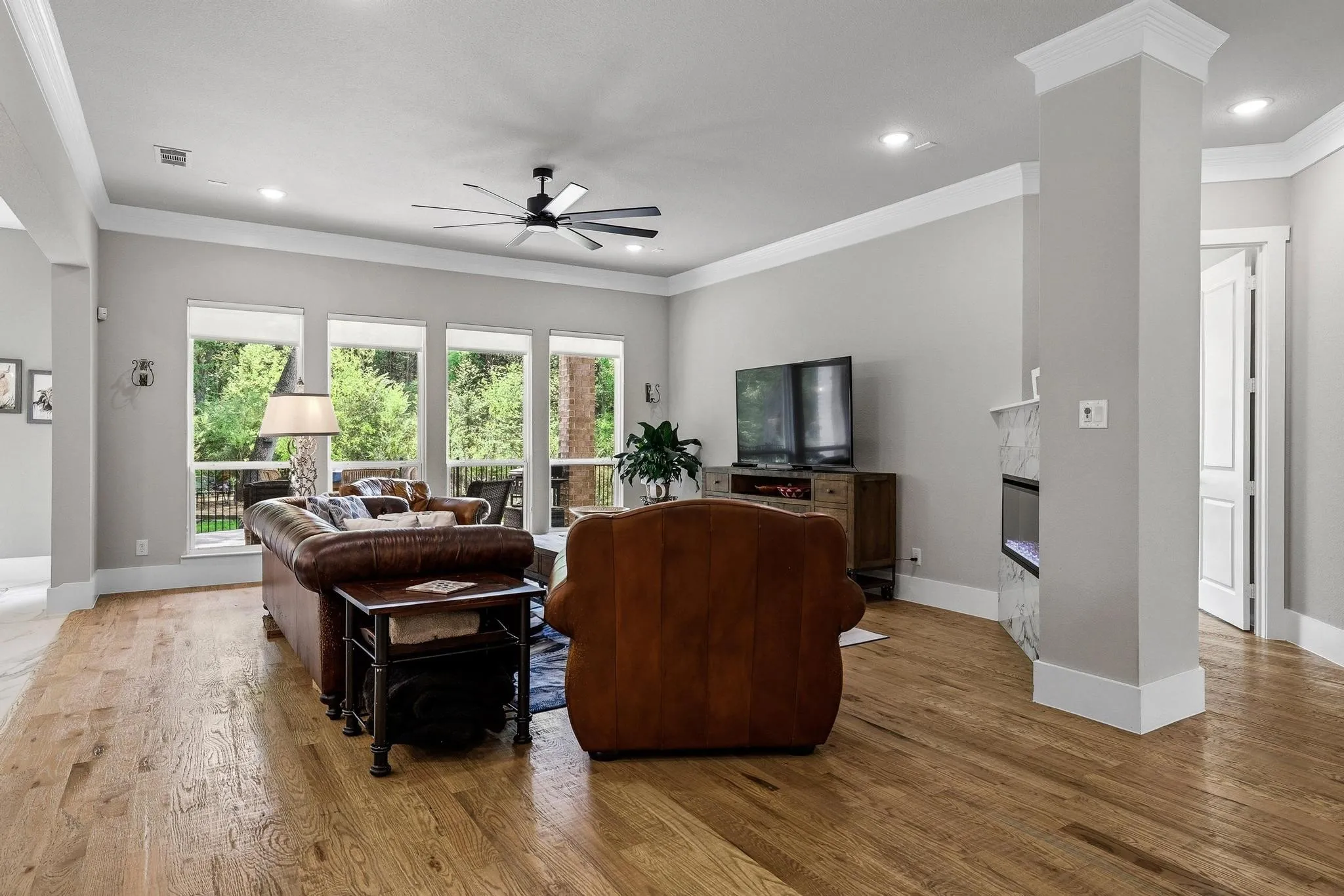 Living room featuring ornamental molding, ceiling fan, light wood-type flooring, and recessed lighting