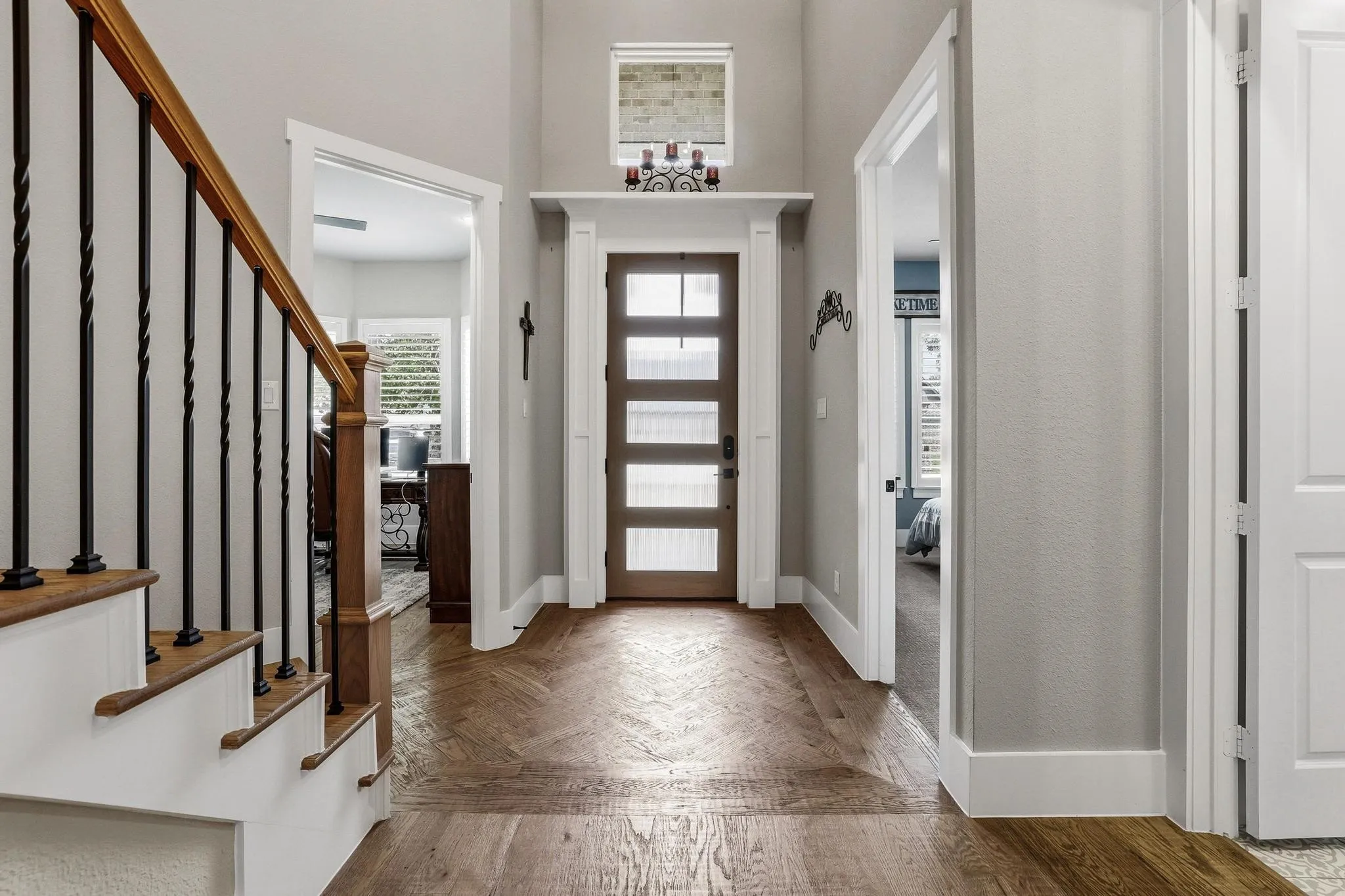 Foyer entrance with stairs and parquet floors