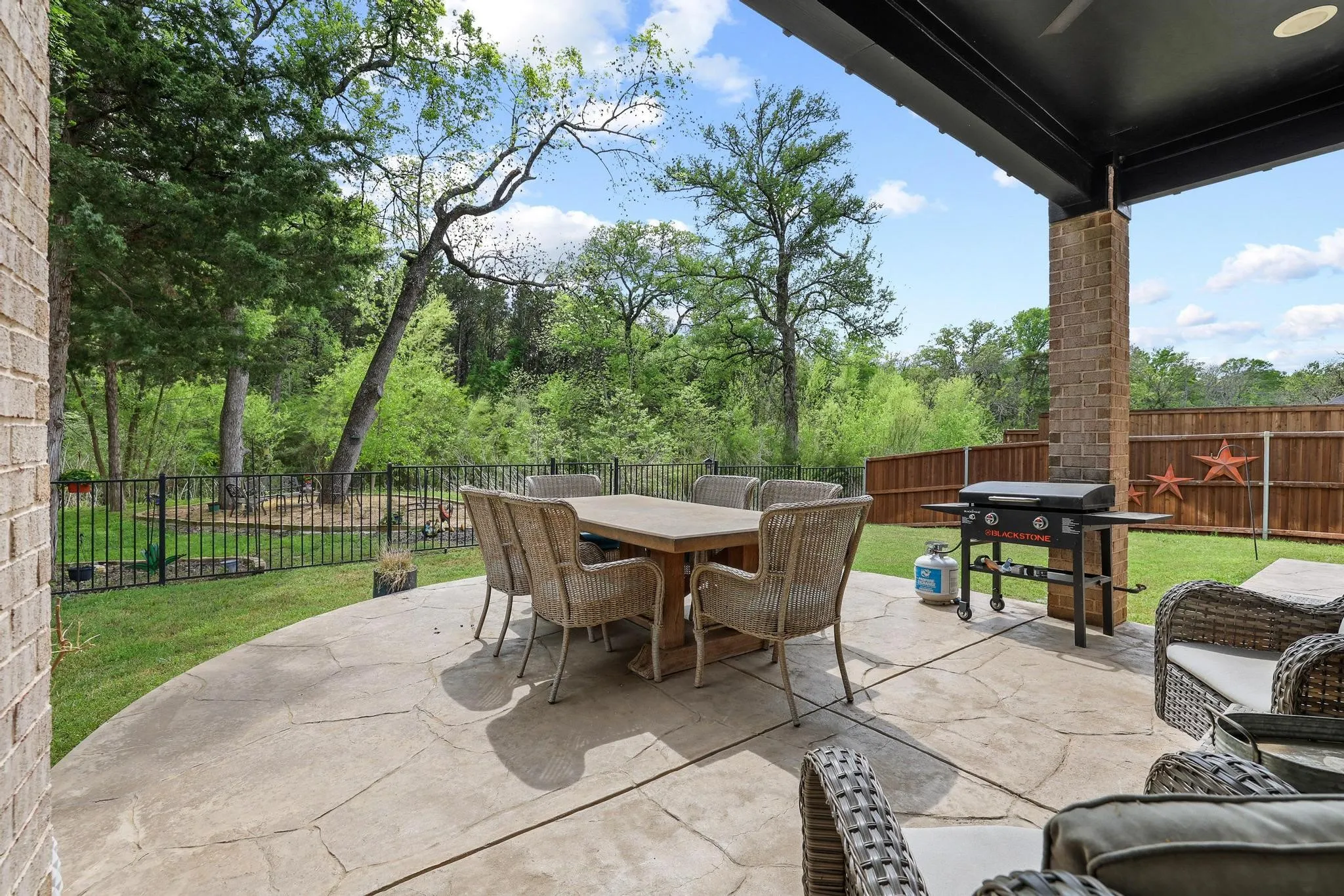 Fenced backyard with a patio, area for grilling, and outdoor dining space