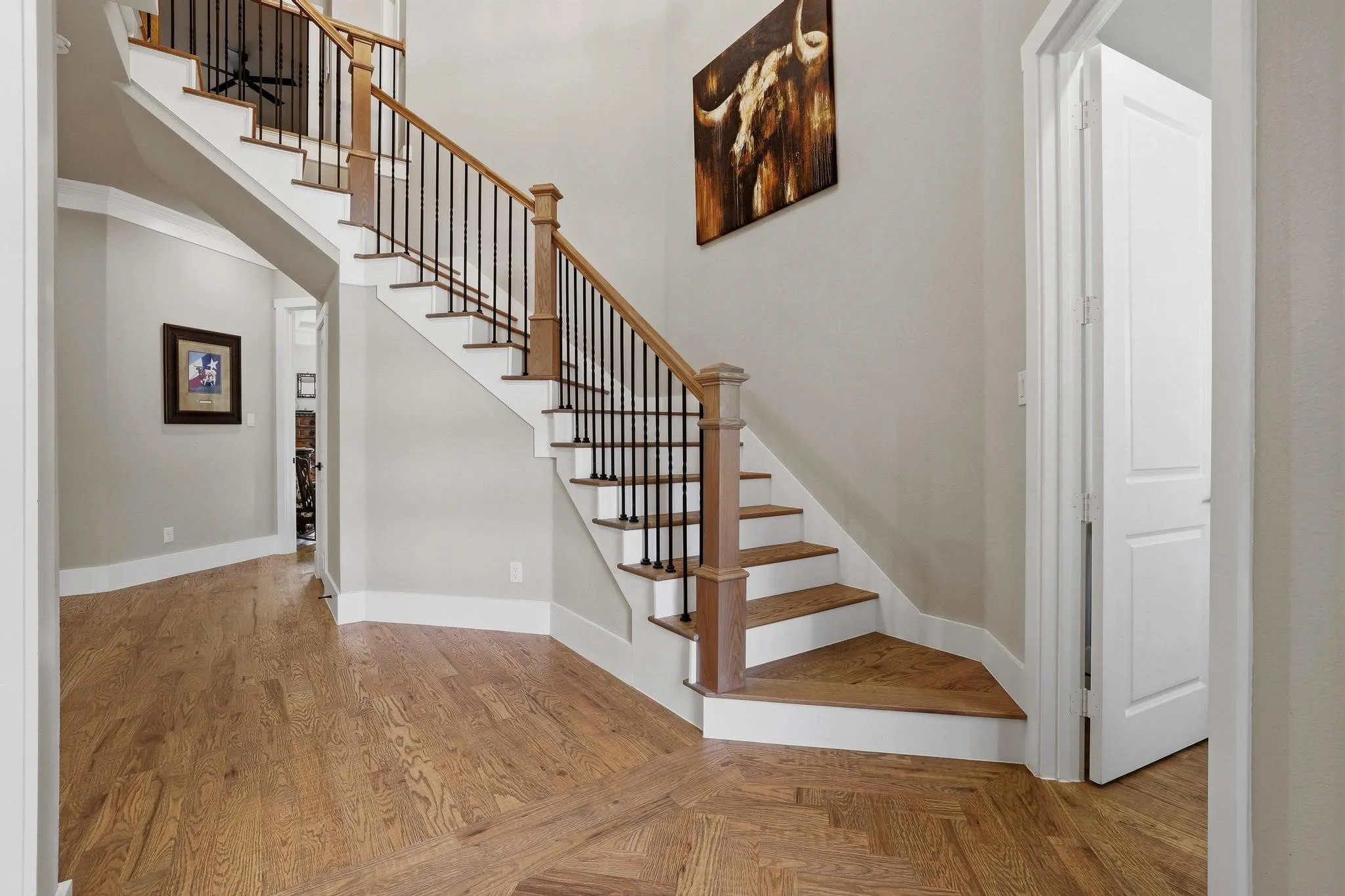 Staircase featuring parquet flooring and a high ceiling