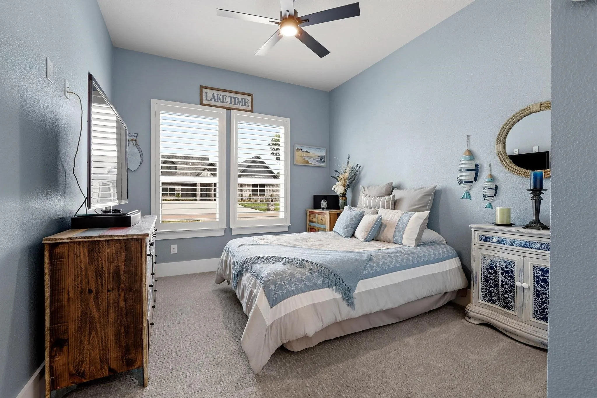 Bedroom featuring light colored carpet and a ceiling fan