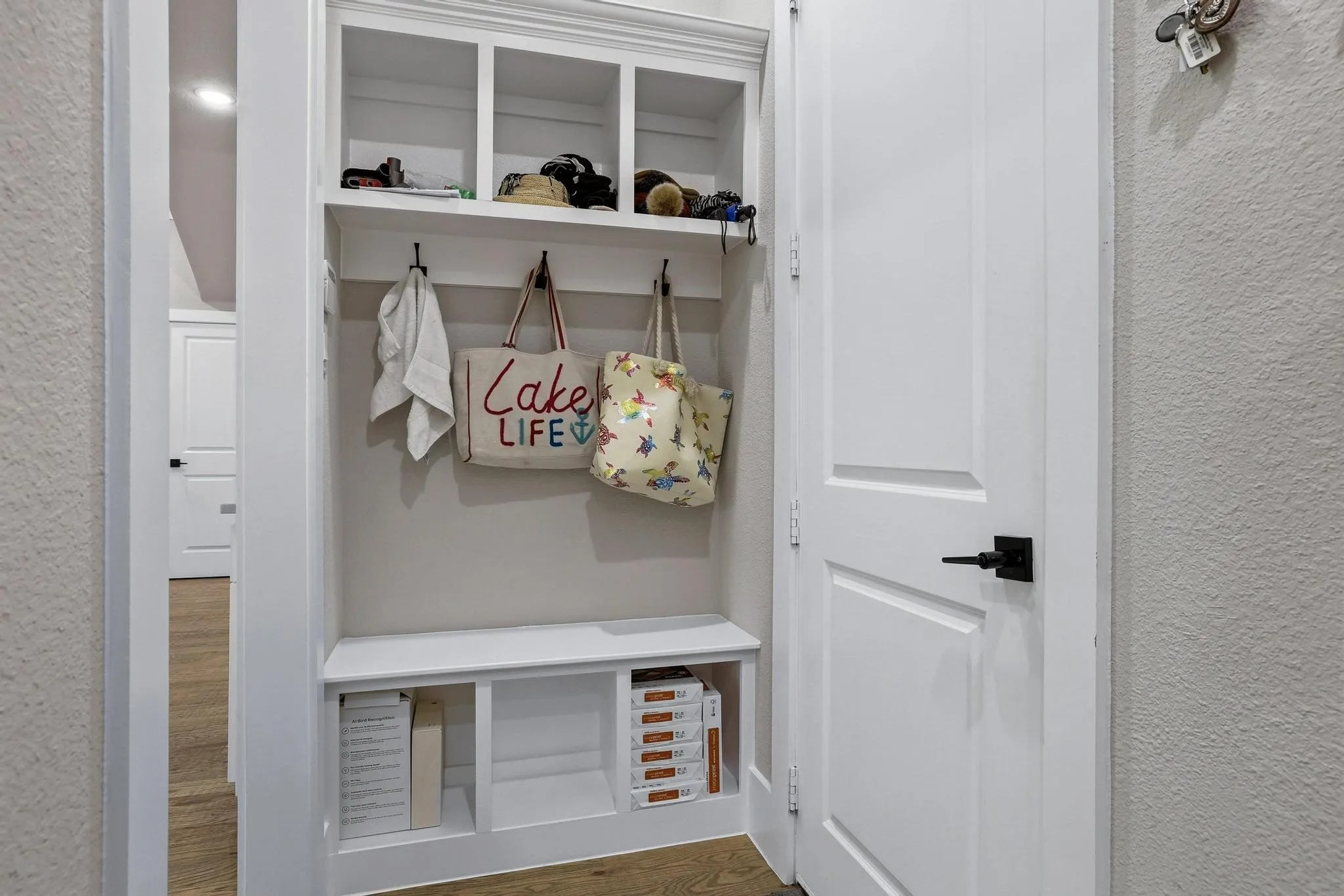 Mudroom with a textured wall and wood finished floors